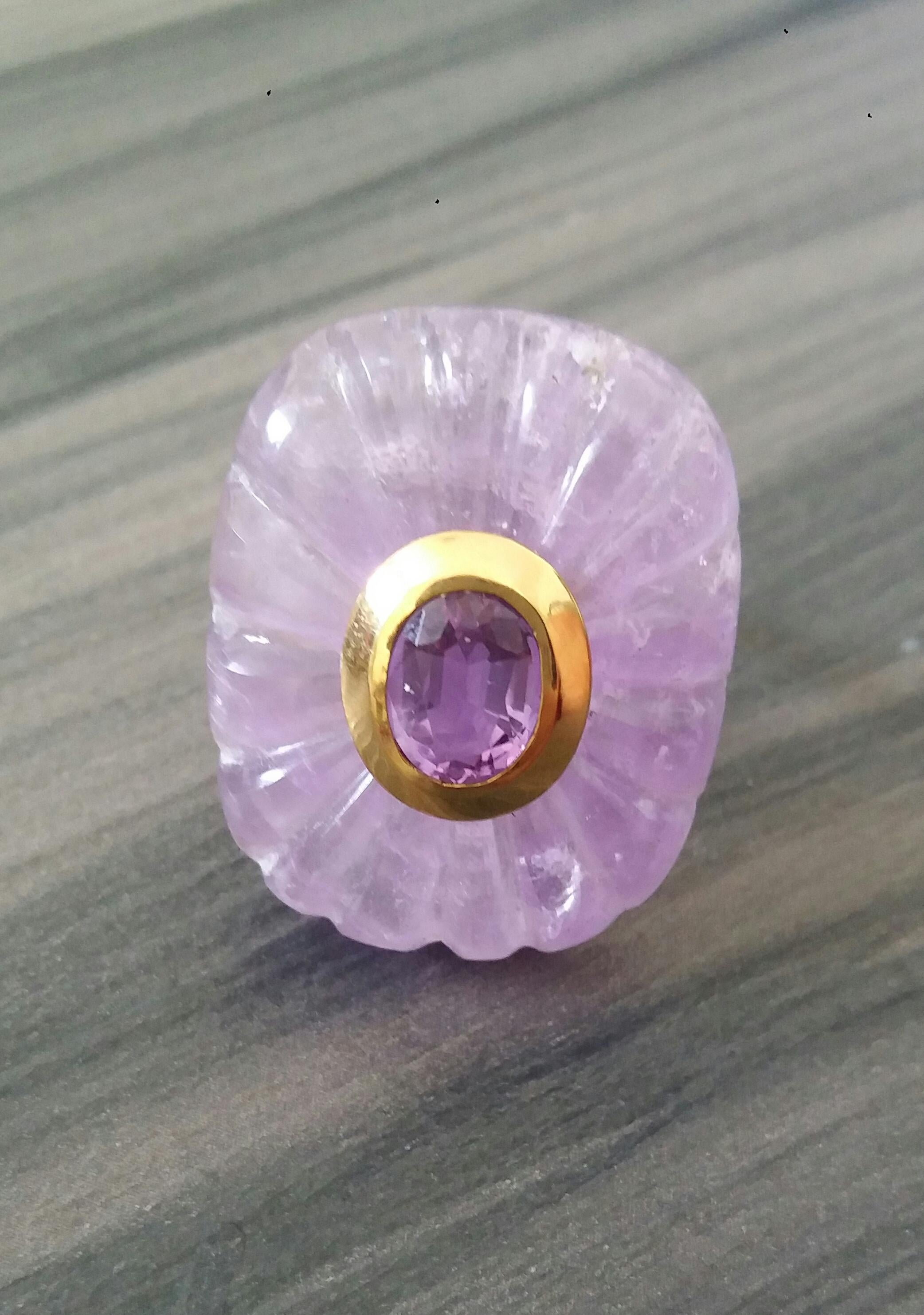 Unique ring with a Big Natural Engraved Cushion Shape Amethyst ,measuring 32 mm. x 24 mm x 8mm. and weighing 63 Carats with a nice Oval Faceted Amethyst measuring 7 mm x 9 mm set in 14 kt yellow gold in the middle...Ring shank is also in 14 kt 