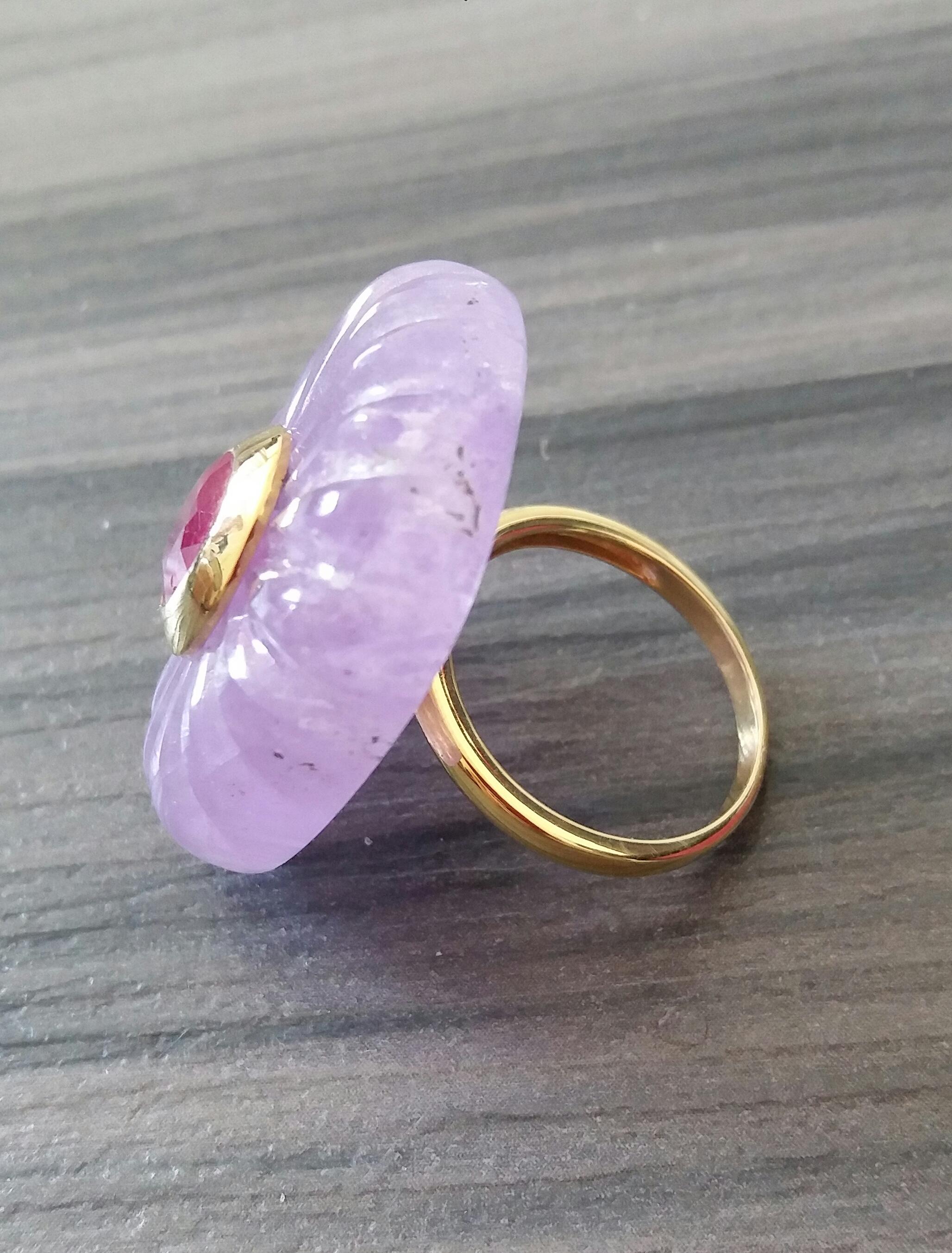 Unique ring with a Big Natural Engraved Cushion Shape Amethyst ,measuring 32 mm. x 24 mm x 8mm. and weighing 63 Carats with a nice Oval Faceted Ruby measuring 7 mm x 9 mm set in 14 kt yellow gold in the middle...Ring shank is also in 14 kt  solid
