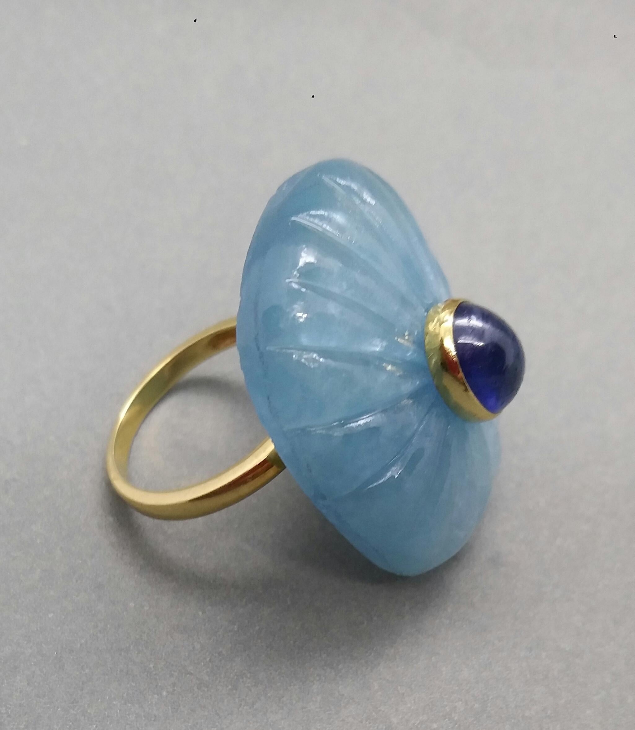 Unique ring with a Big Natural Engraved Cushion Shape Aquamarine ,measuring 30 mm. x 23 mm x 8mm. and weighing 54 Carats with a nice Oval Blue Sapphire Cabochon measuring 6 mm x 8 mm set in 14 kt yellow gold...Ring shank is also in 14 kt  solid