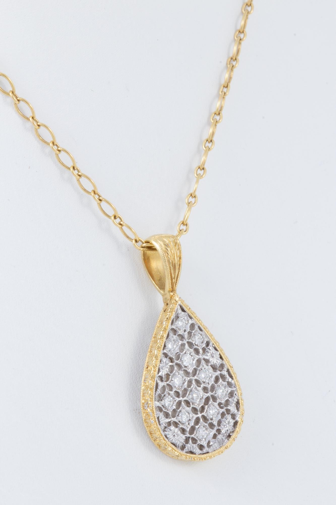 Created in Italy, this classic pendant is hand engraved 18K white and yellow gold.  Total diamond weight is .18ct, and the 18