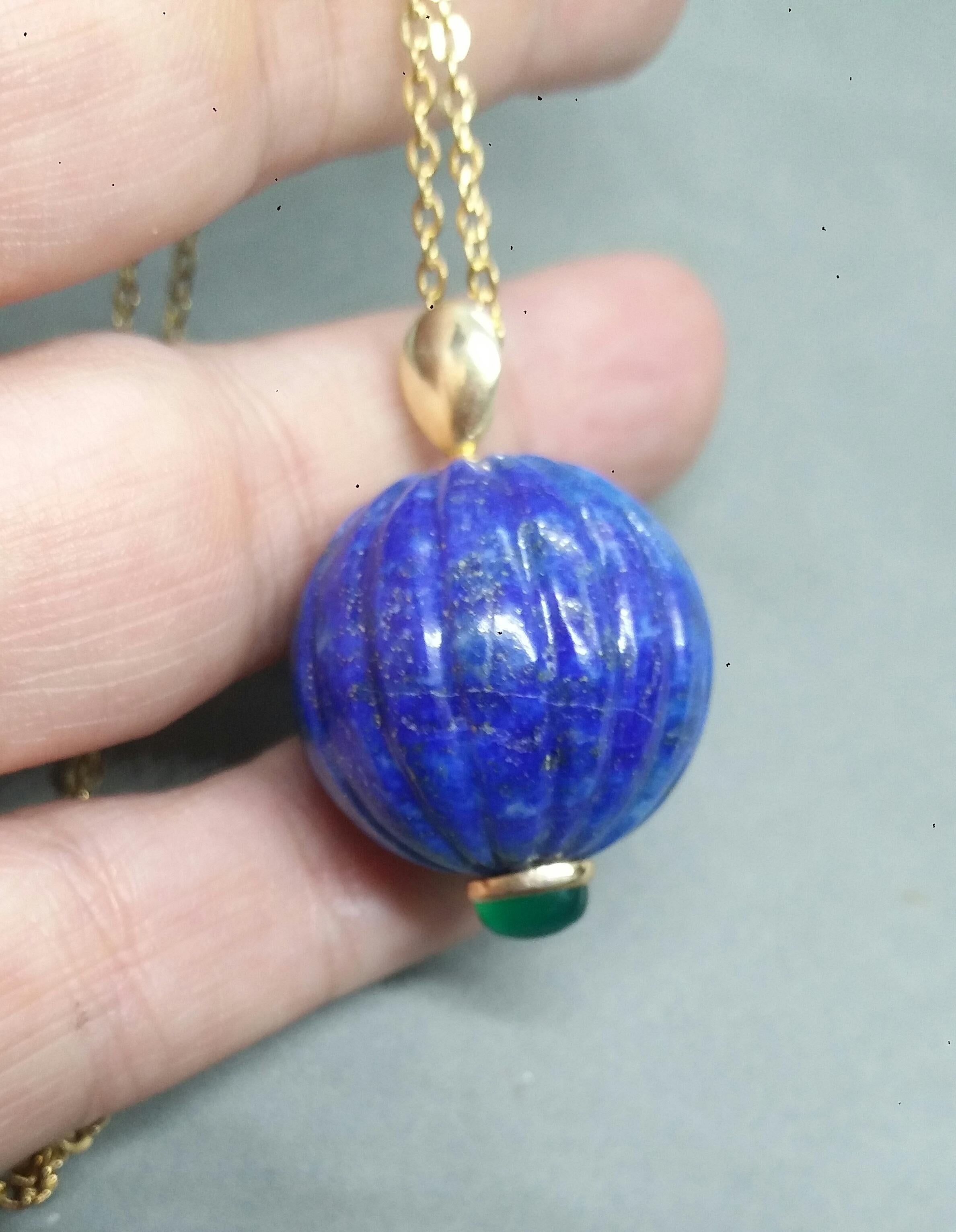 A unique pendant made of an Engraved Genuine Lapis Lazuli Round Bead 25 mm in diameter,set with an oval Green Onyx Cabochon measuring 6x8 mm. and a yellow gold pendant bail on the top part.

In 1978 our workshop started in Italy to make simple-chic