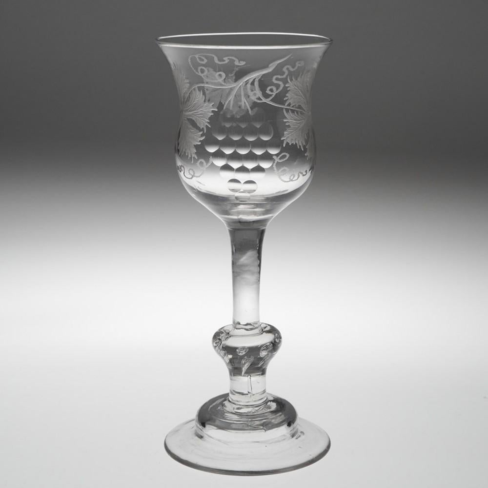 Engraved Georgian Balustroid Wine Glass, circa 1740

Additional information:
Period : George II c1730-40
Origin : England 
Colour : Clear 
Bowl : Tulip shapes with engraved with a fruiting vine leaves with polished detail and moth or butterfly