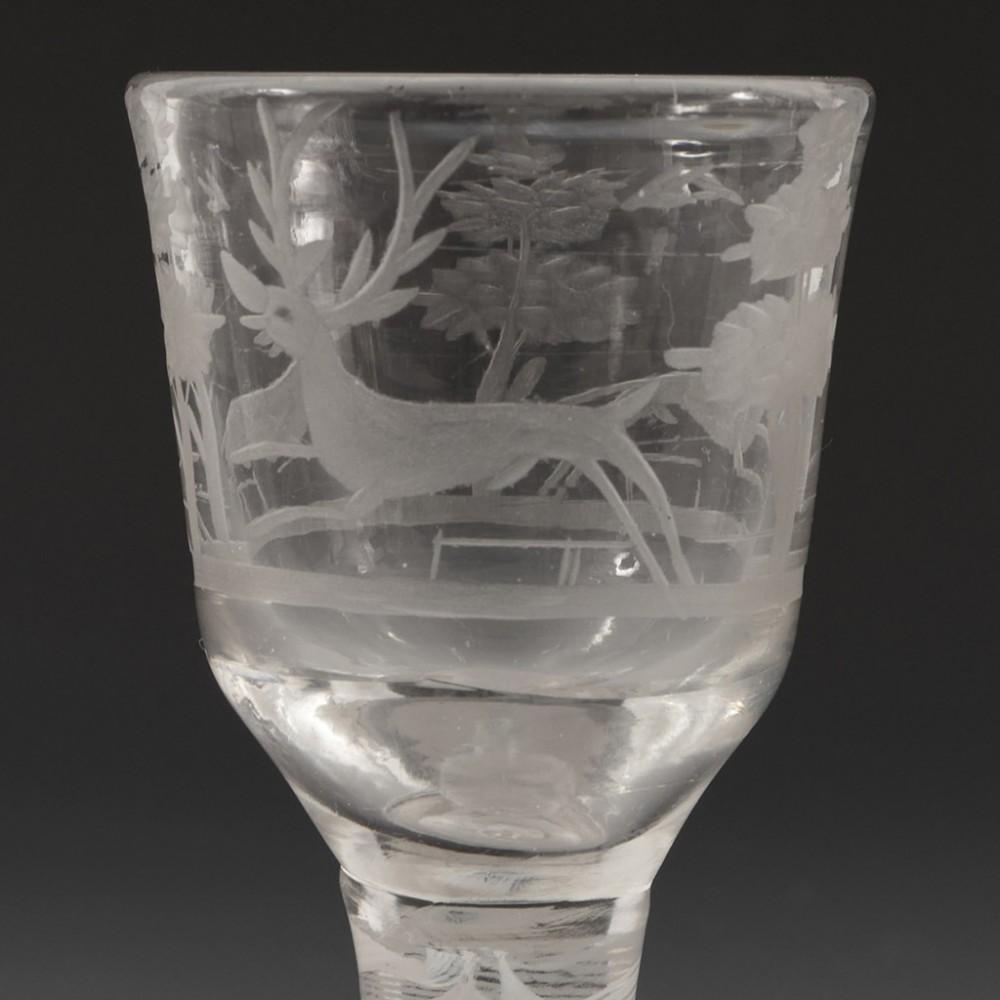 Heading : Double series opaque twist Georgian cordial glass
Period : George II / George III - c1760
Origin : England
Colour : Clear
Bowl : Round funnel - engraved with hounds chasing a stag through a woodland landscape
Stem : A 12-ply spiral band