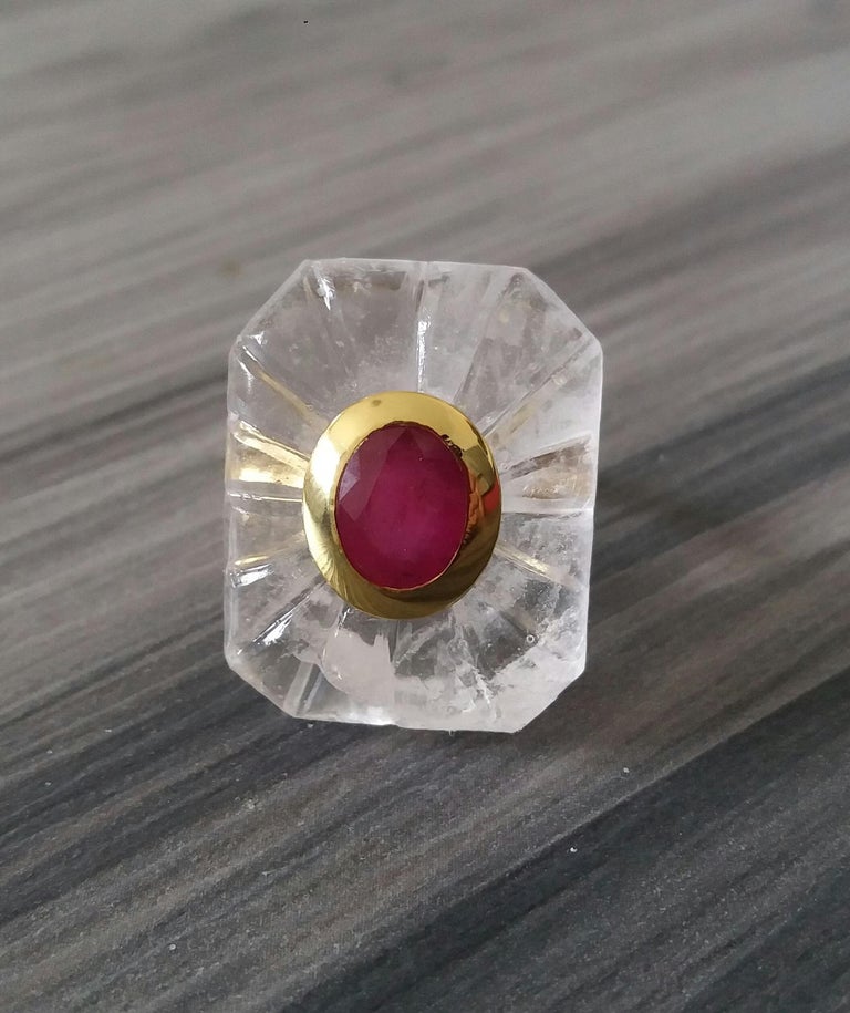 Unique ring with a Big Natural Engraved Rock Crystal Quartz Cab ,measuring 28 mm. x 22 mm x 8mm. and weighing 53 Carats with a nice Oval Faceted Ruby measuring 8 mm x 10 mm set in 14 kt yellow gold...Ring shank is also in 14 kt  solid yellow gold