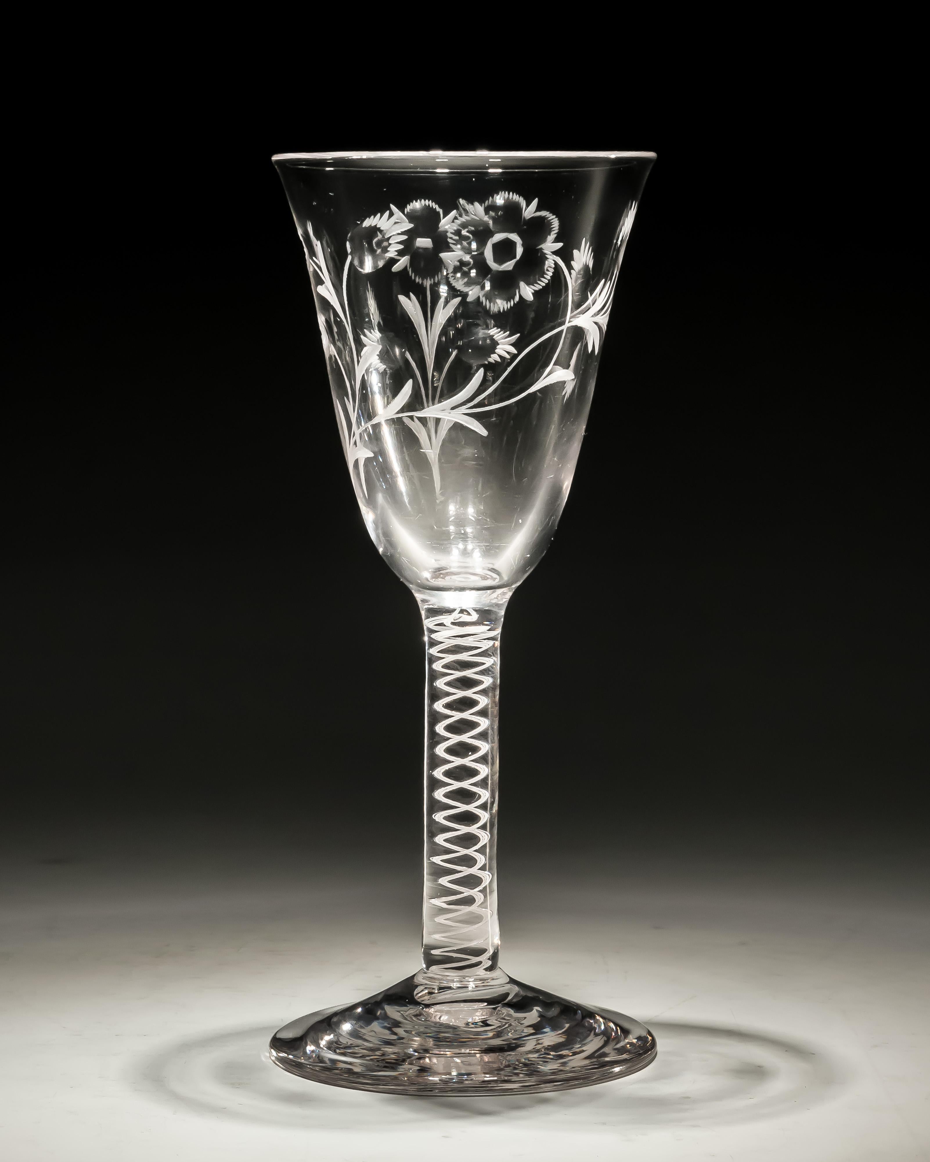 An engraved opaque twist wine glass.

England, circa 1770.

Measures: Height: 17 cm (6 3/4