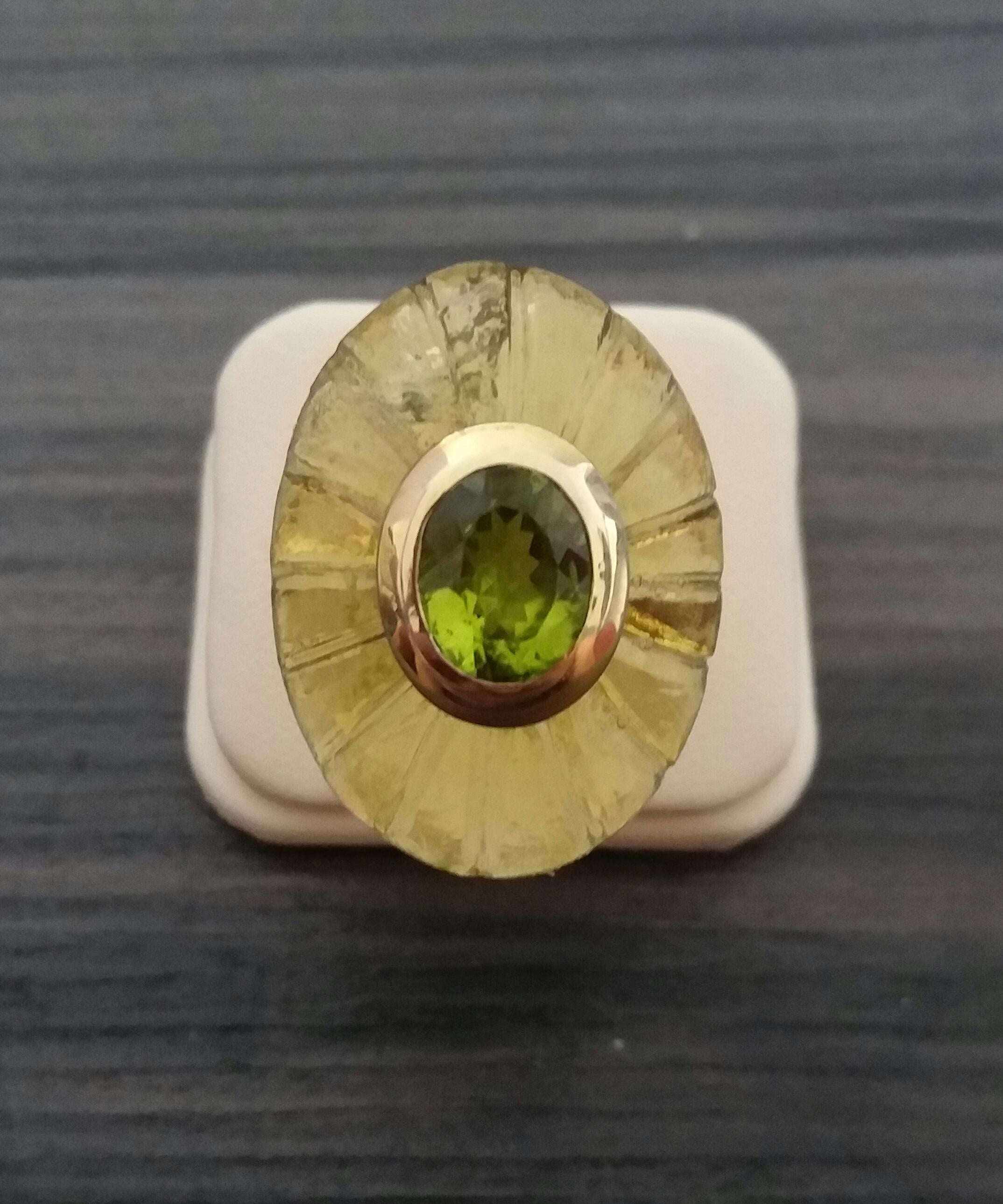 Unique ring with a Big Natural Engraved Lemon Quartz Cab ,measuring 30 mm. x 23 mm x 10mm. and weighing 53 Carats with a nice Oval Faceted Peridot measuring 8 mm x 10 mm set in 14 kt yellow gold...Ring shank is also in 14 kt  solid yellow gold now