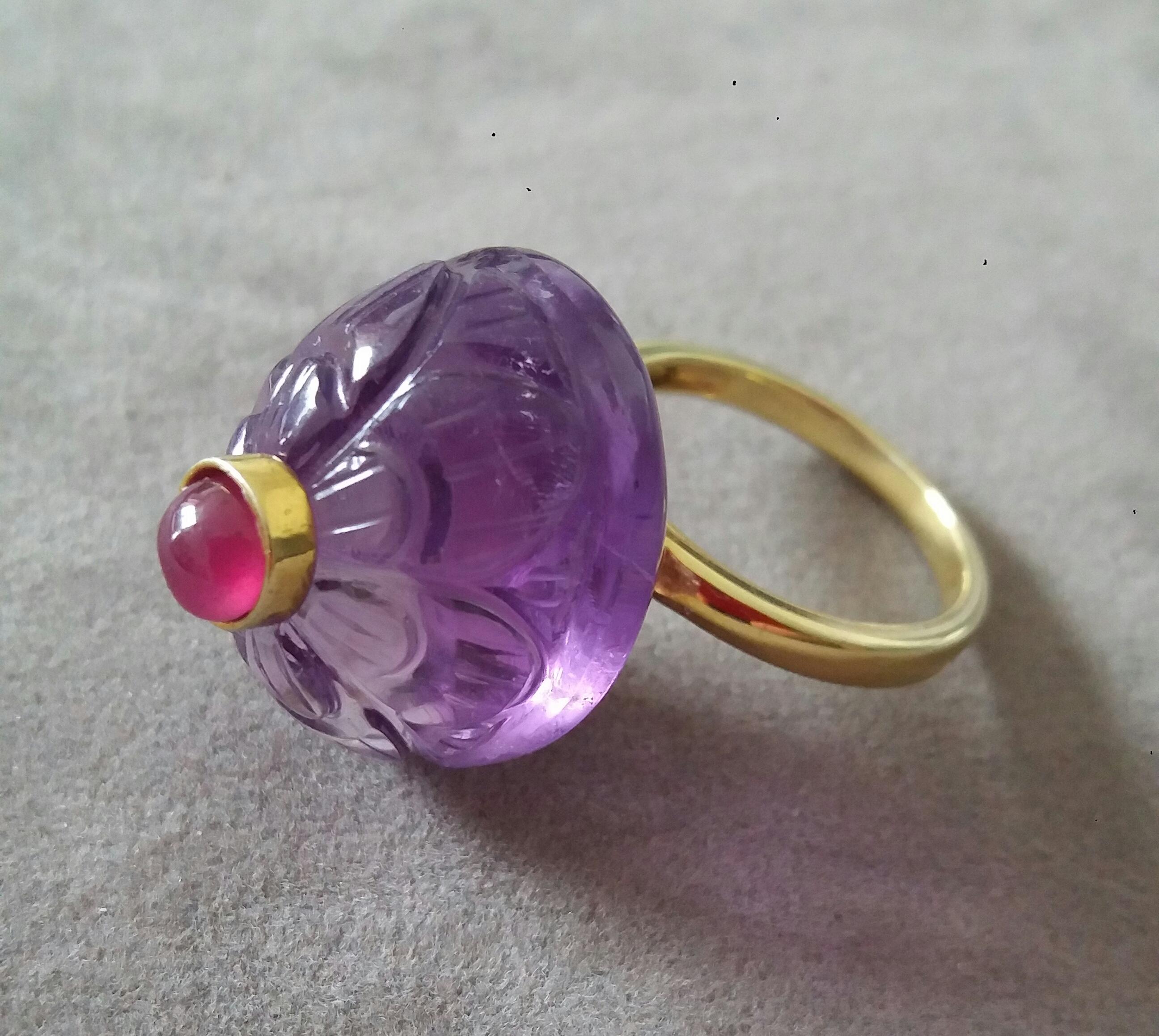 Unique style ring with a Big Natural Engraved Oval Shape Amethyst ,measuring 22 mm. x 18 mm x 14 mm. and weighing 41 Carats with a nice Round Ruby Cab measuring 6 mm in diameter  set in 14 kt yellow gold in the middle...Ring shank is also in 14 kt 