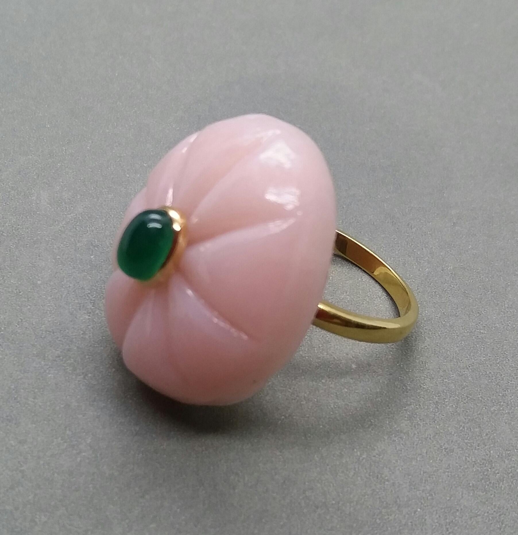 Unique ring with a big Engraved Oval Shape Pink Opal ,measuring 28 mm. x 24 mm x 8mm. and weighing 38 Carats with a nice Oval Emerald Cabochon measuring 6 mm x 8 mm set in 14 kt yellow gold...Ring shank is also in 14 kt  solid yellow gold now in