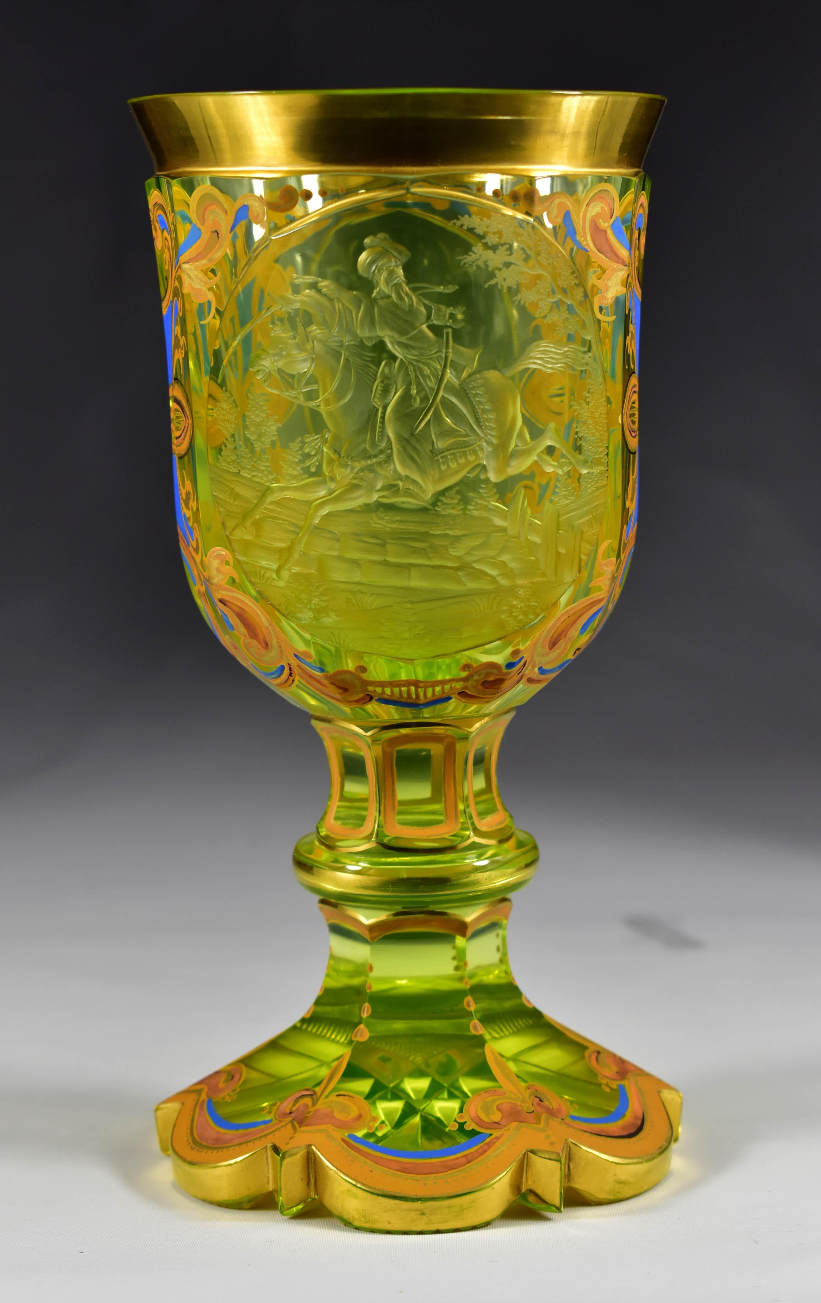 Beautiful cut uranium glass goblet decorated with painting and engraving. It is a facet cut with two medallions. There is also a beautifully cut bottom in the shape of a star. In the front medallion there is an engraving of a rider on a horse