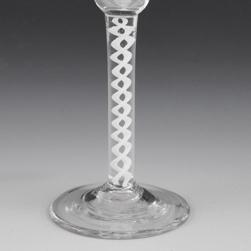 Heading : Engraved Pan Top Single Series Opaque Twist Wine Glass
Period : George III
Origin : England
Colour : Clear
Bowl : Pan top round funnel, Engraved cross-hatched vesicas and stars
Stem : A pair of corkscrew opaque tapes
Foot : Conical
Pontil