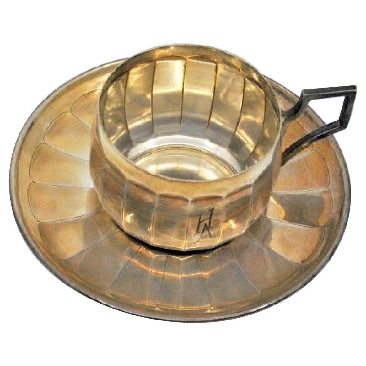 Engraved silver cup and saucer