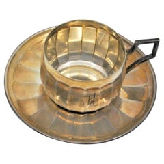 Engraved silver cup and saucer