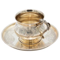 Engraved silver teacup and saucer
