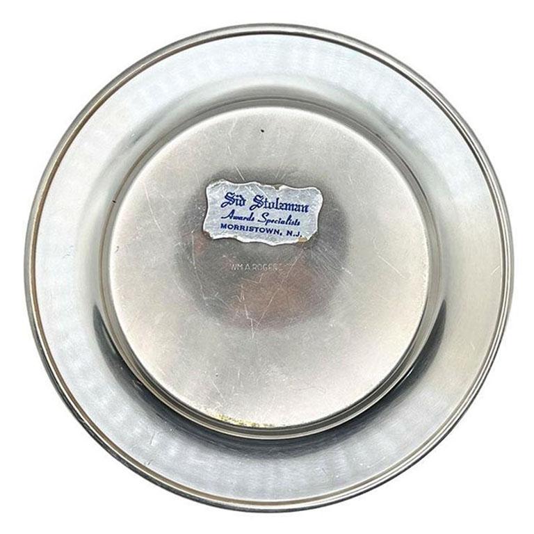 A petite silver plate golf club trophy plate. This plate will be great hung on a wall with a current collection. (Or this could be the start of one!) It is round, and stamped with the WM A Rogers stamp on the underside. The top is engraved with SB