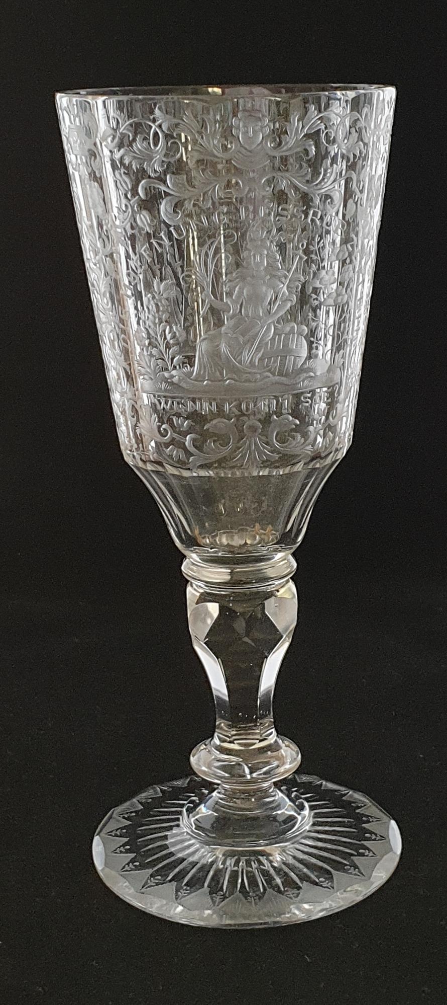 A fine wine-glass, elaborately engraved with scroll-work, figures and religious inscriptions. Translations are rather approximate.

die hoffnung bessrer zeiten wenn komt sie
the hope of better times when it comes

nacht gut wo sind sie?
Good