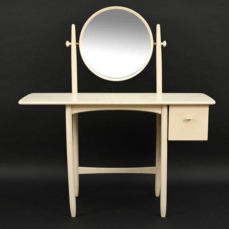 A rare Swedish mid-century dressing table or vanity designed by Sven Engstrom & Gunnar Myrstrand. Produced by Bodafors in 1964. Solid oak base in eggshell lacquer finish, single drawer and round adjustable angle mirror, with stylish brass details.