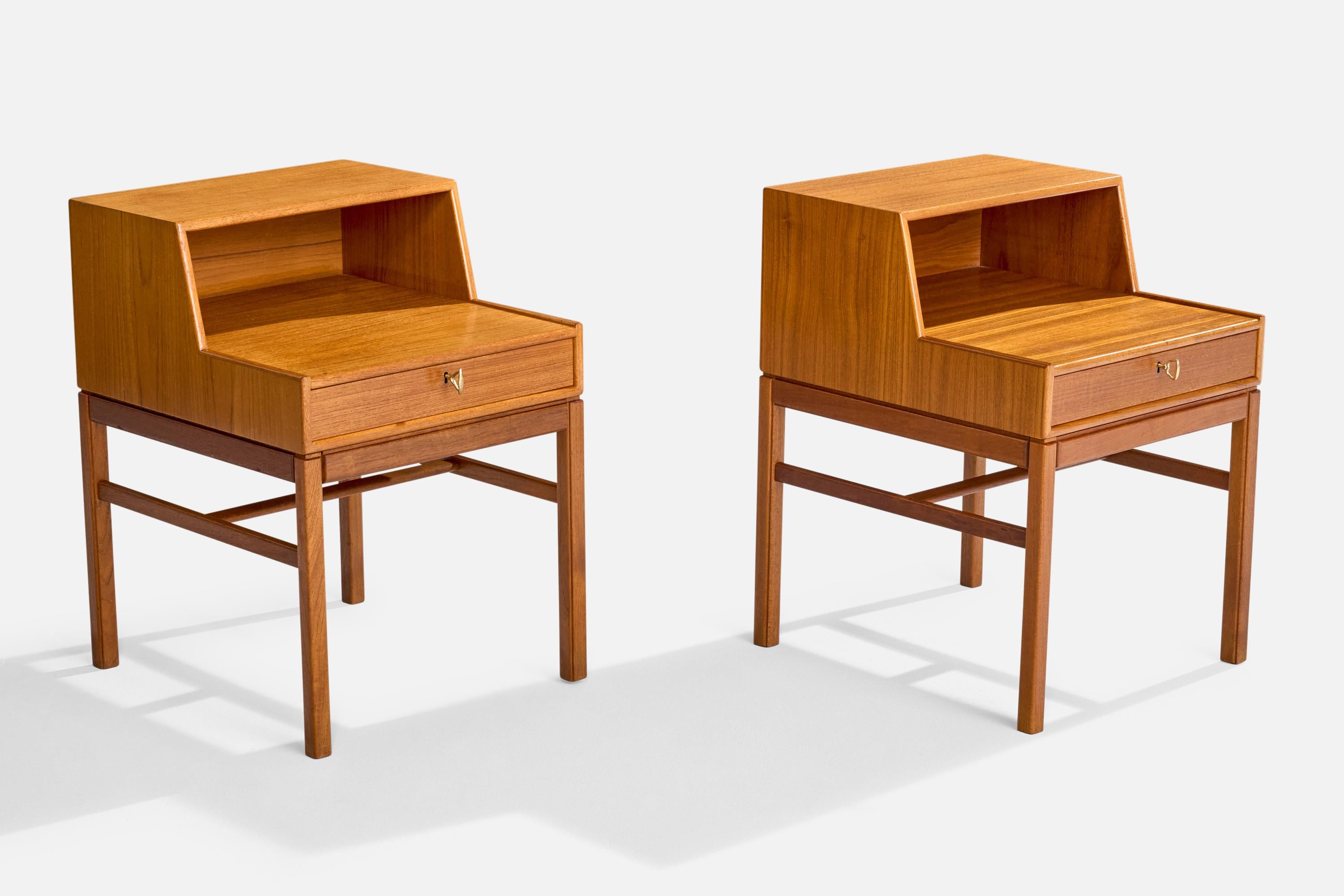 A pair of teak and brass 