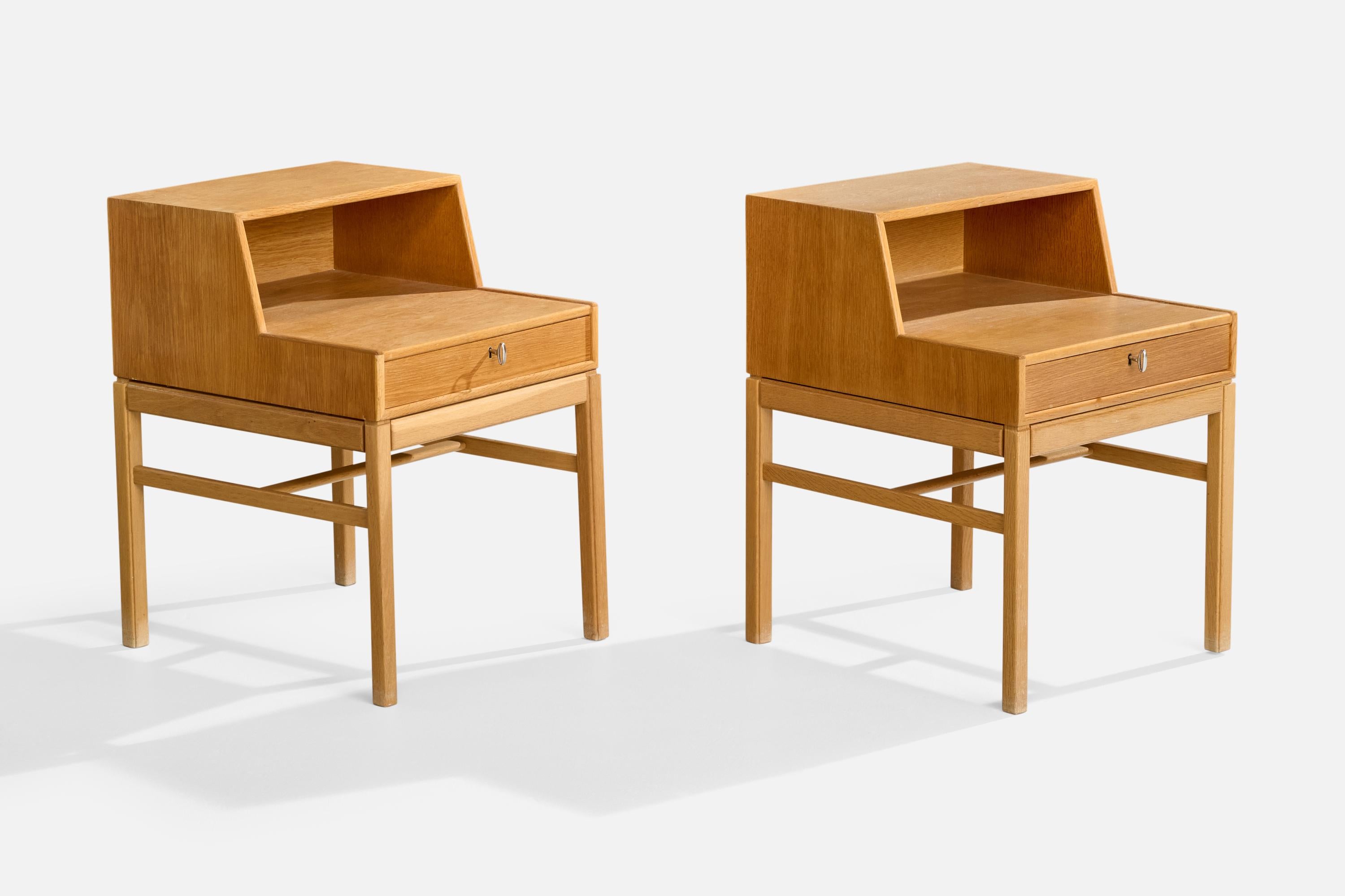A pair of teak and brass 