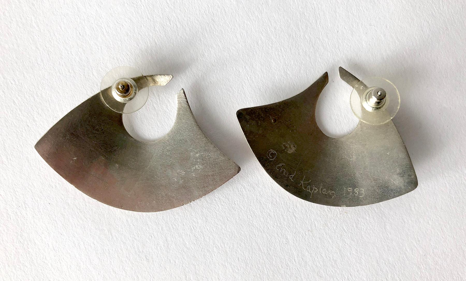 Married metals post modernist earrings of sterling silver, 14k gold and brass with onyx accent, created by artist and jeweler Enid Kaplan of New York City.  Earrings measure 1 1/4