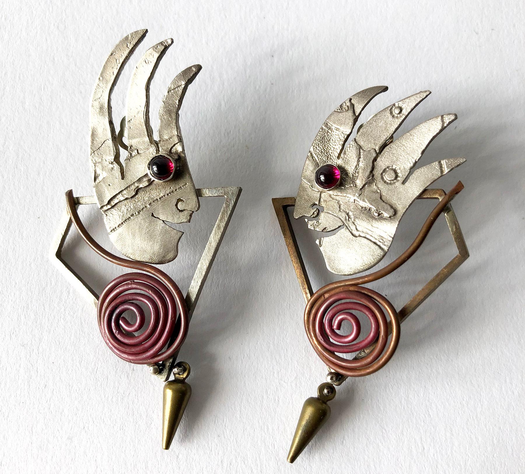 Pair of hand made sterling silver, 14k gold, brass, carnelian and onyx earrings created by New York jeweler and artist, Enid Kaplan.  Earrings are of the clip back variety and are signed Enid Kaplan, 1997.  In very good, unworn vintage condition. 