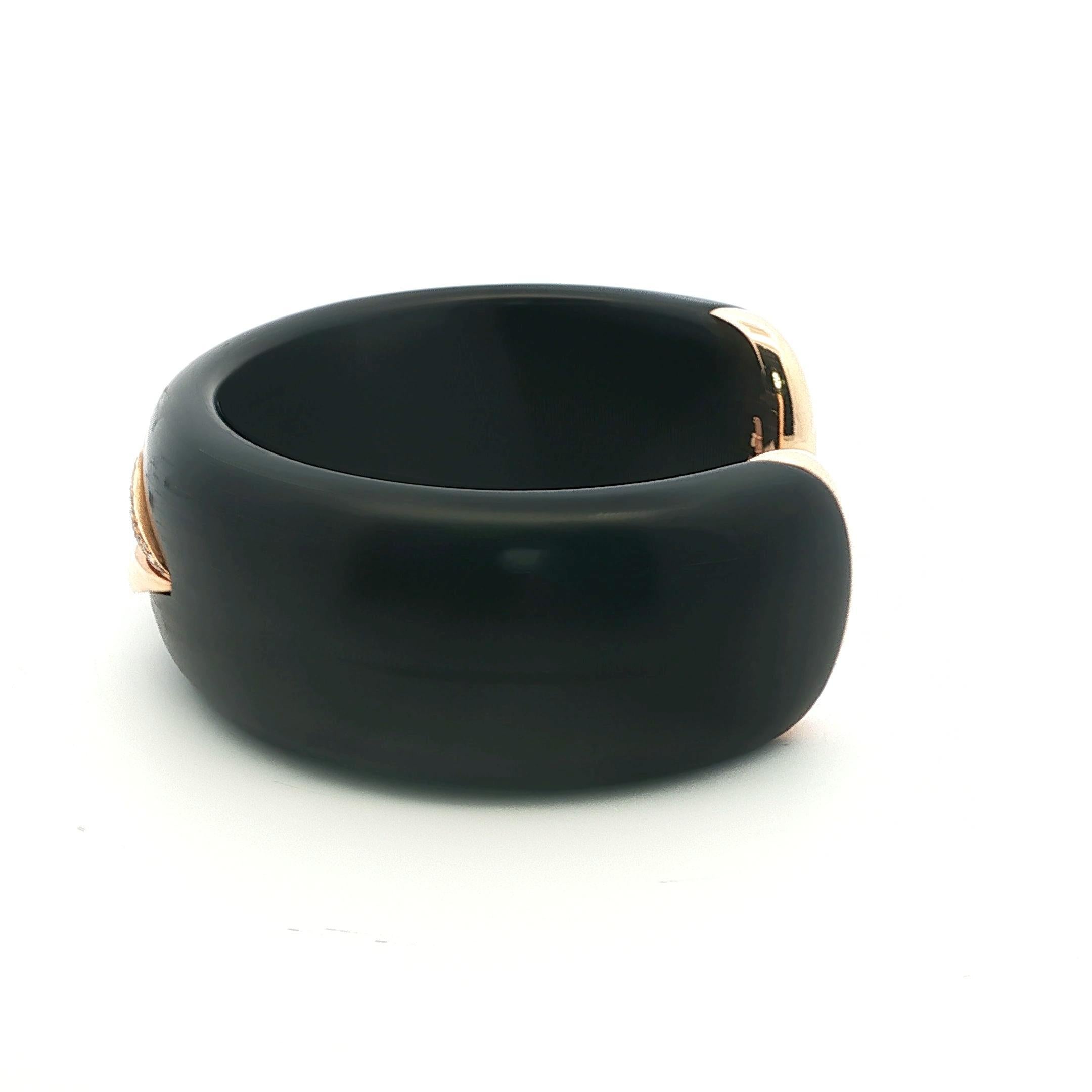 For the woman whose silence speaks volumes.

Crafted in Italy in 2020, this sculptural bangle by Enigma—designed by Gianni Bulgari—blends natural warmth and polished luxury. A high-gloss, dark wooden cuff cradles an 18k yellow gold mouth, delicately