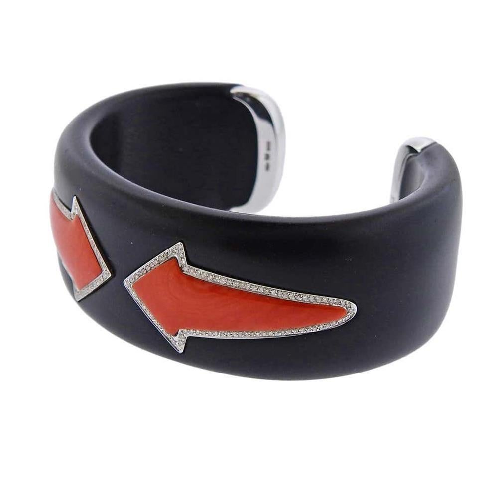 18k gold and black jet cuff by Gianni Bulgari from Enigma collection, set with two coral arrows, surrounded with approx. 0.28ctw in diamonds. The bracelet will it approx. 7