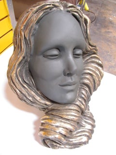 Enigmatic Sculpture of a Mermaid Face