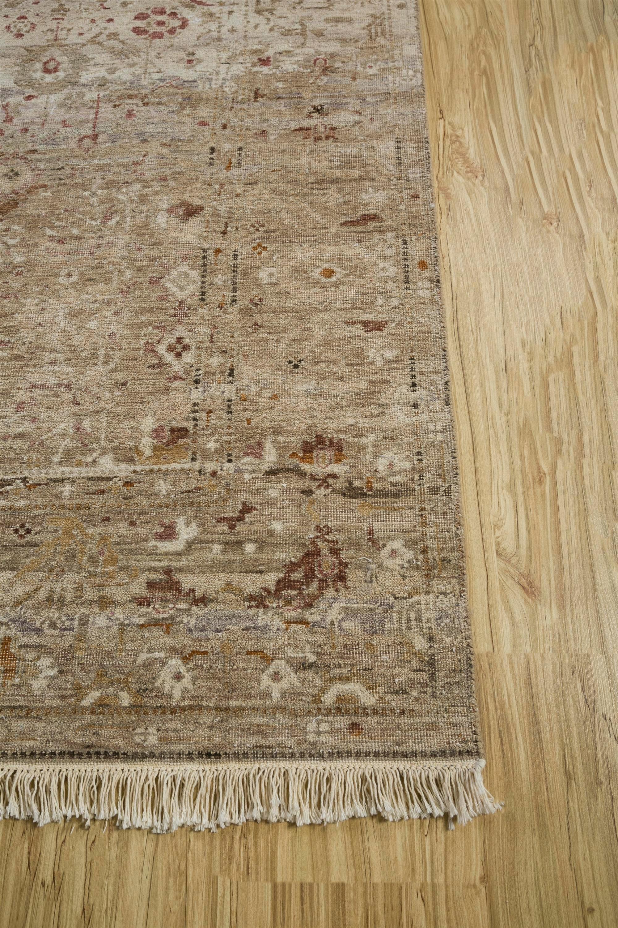 Transform your living space into a haven of timeless charm with our exquisite hand-knotted rug, a true masterpiece crafted from wool and silk. Immerse yourself in the rich, earthy tones of clay, harmoniously paired with a soft beige border, adding a