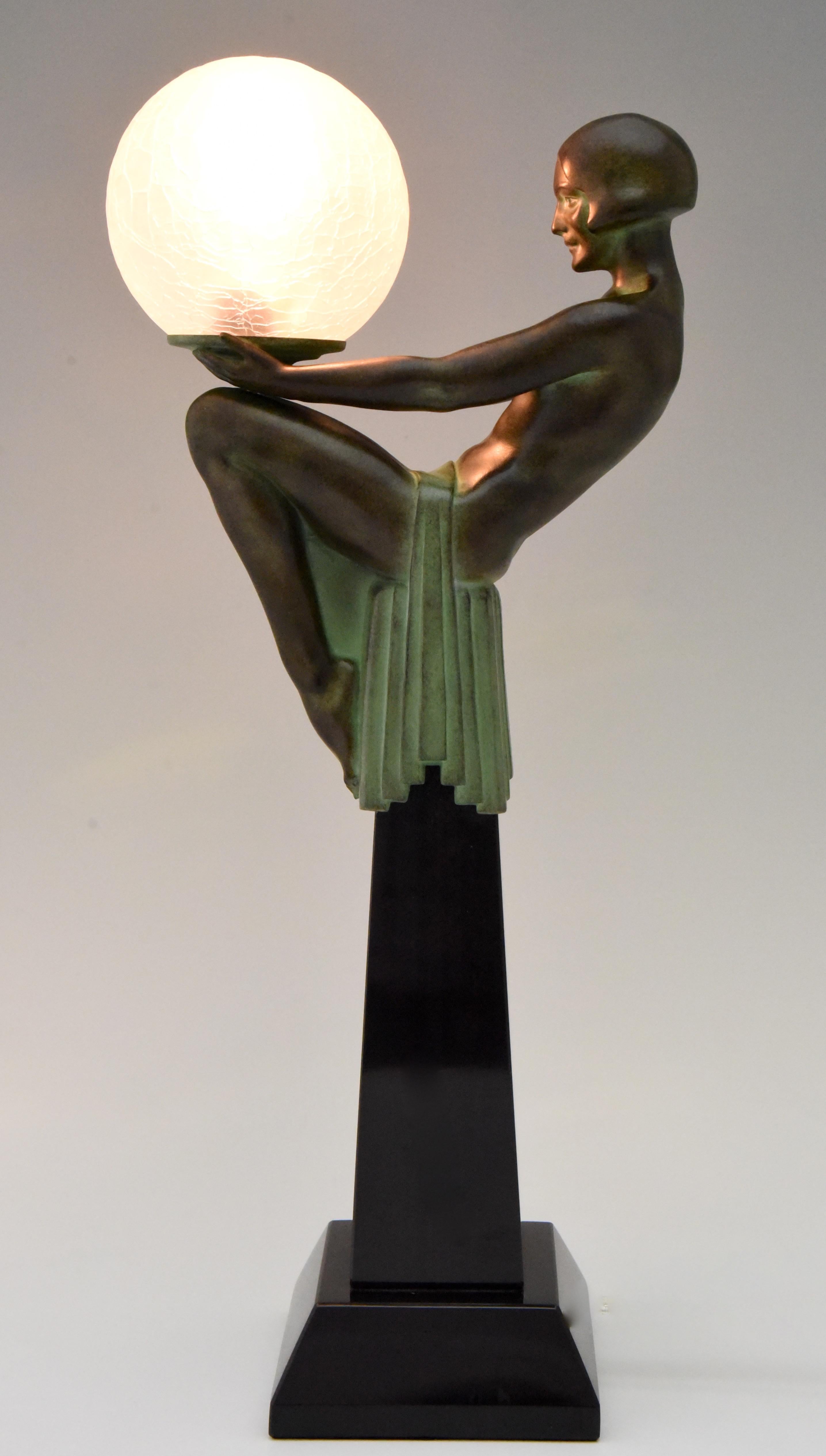 Enigme, Art Deco style figural table lamp of a seated nude holding a glass shade signed M. Le Verrier with foundry mark. 
Patinated Art Metal on a Black marble base. Crackled glass globe. 
Posthumous contemporary cast at the Le Verrier foundry in