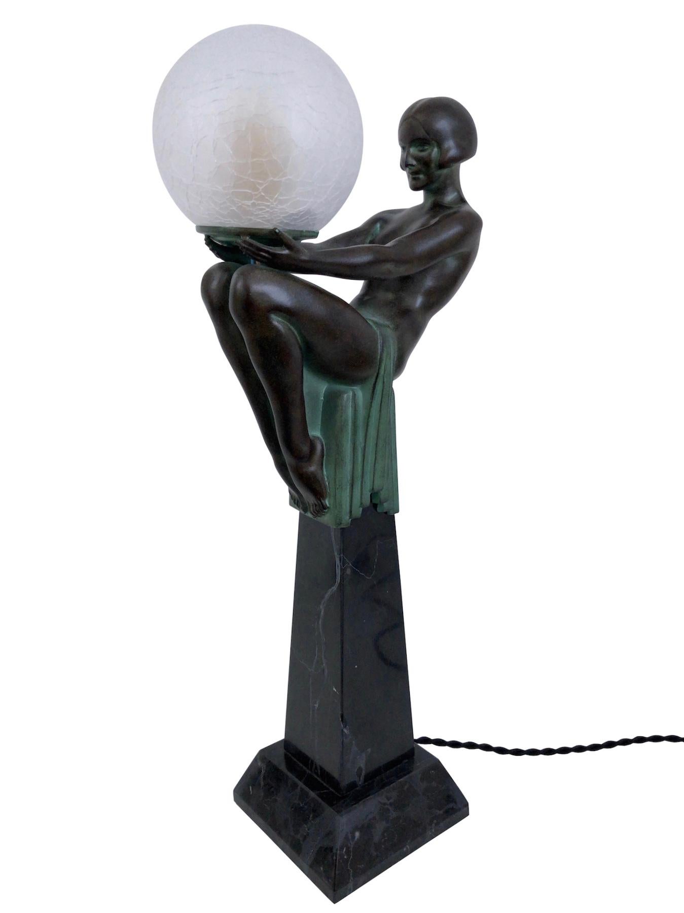 “Enigme” 
Original “Max Le Verrier”
Sculpture in Art Deco style, France 

Beautiful lady sitting on an Obelisk. 
She seems to be hypnotized and fascinated by the lighted Glass Ball. 
The lady wears a haircut typical for Art Deco: the bob. 
The