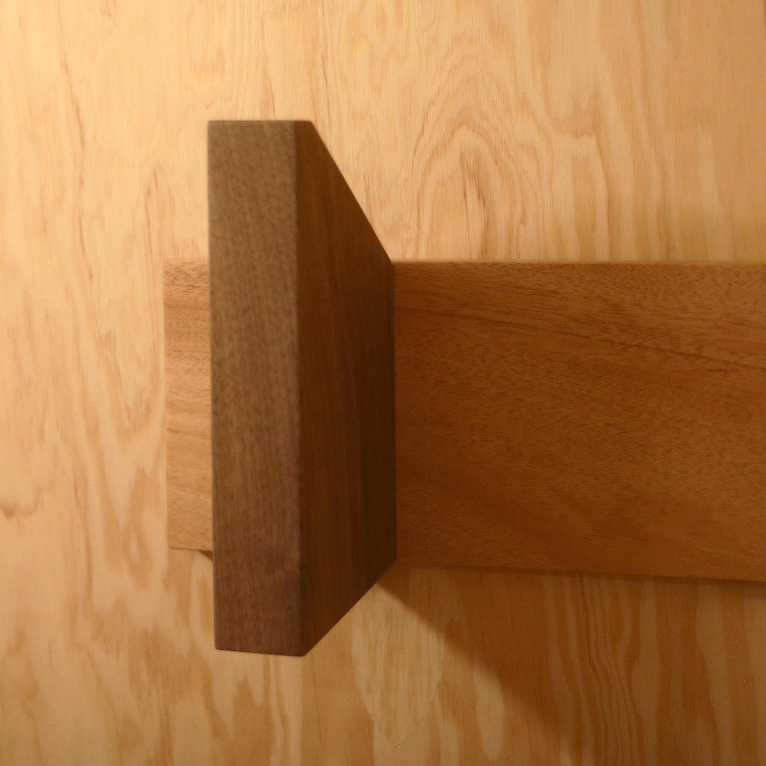 The Enki is constructed using combined woods of solid walnut and mohogany.  The design is simultaneous subtle and expressive.  The larger scale of the rack hooks make this a very interesting design detail for any space requiring storage for towels,