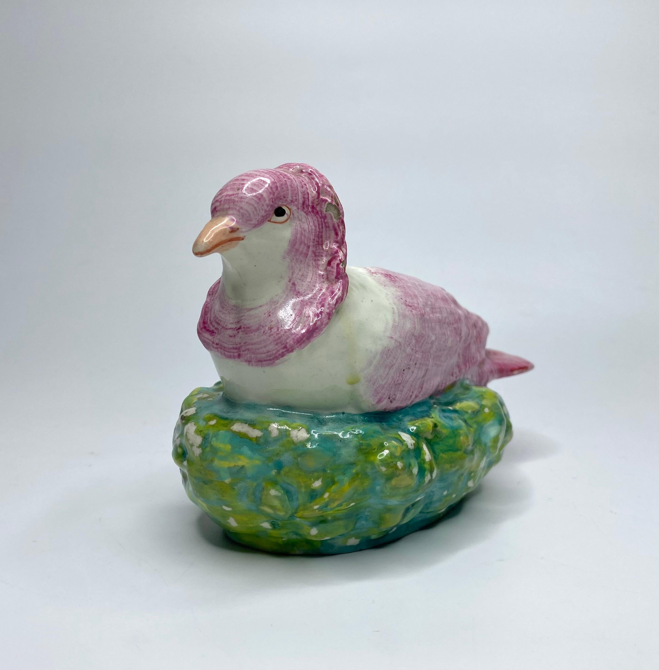 Staffordshire pottery figure of a Dove, Enoch Wood, c. 1820. Well modelled as a dove, on its nest. The doves feathers well delineated, and heightened in puce enamel. It’s nest naturistically coloured in green, yellow and brown enamels.
Length – 17.7