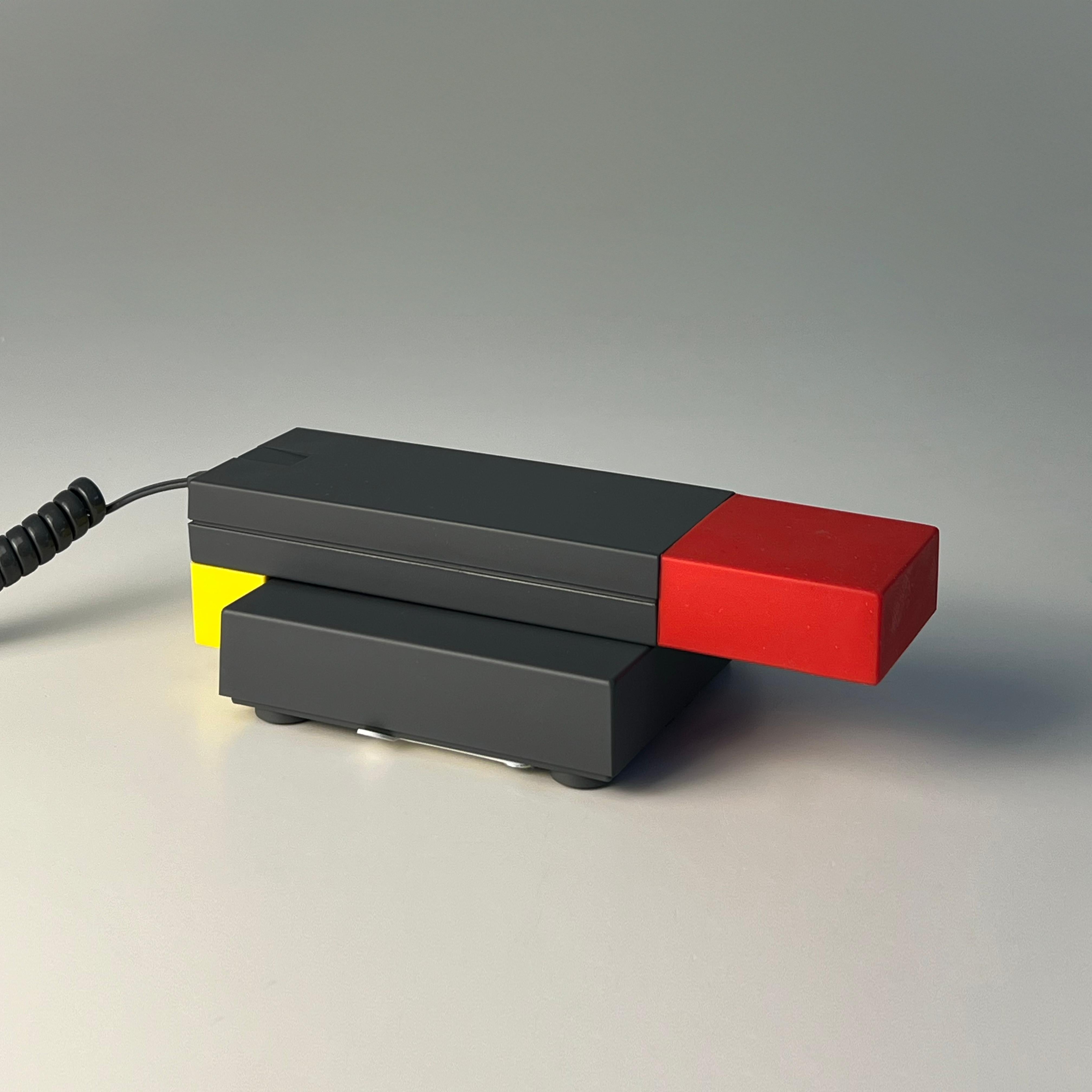 Enorme Telephone Handset designed by Ettore Sottsass for Brondi, Italy 1986
This telephone handset, a quintessential example of postmodern design, stands as a testament to the creative genius of Ettore Sottsass. It was produced in 1986 by the