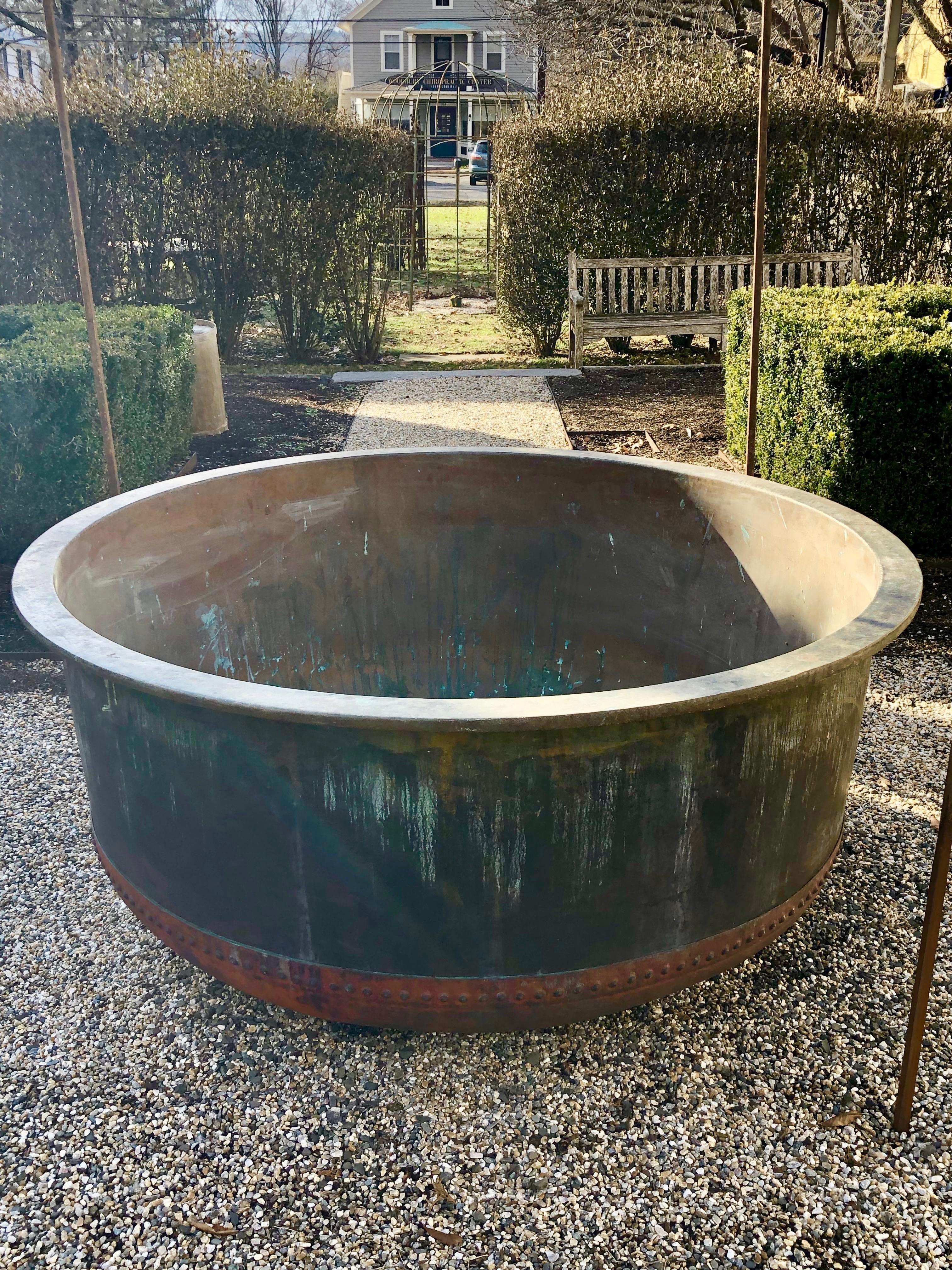 What a find! Made of heavy double-walled copper with an iron ring underside the lip and a hand-riveted bottom in a natural dark red surface, this huge tub was originally used to cook the milk for cheese in 19th century France. We have had three of