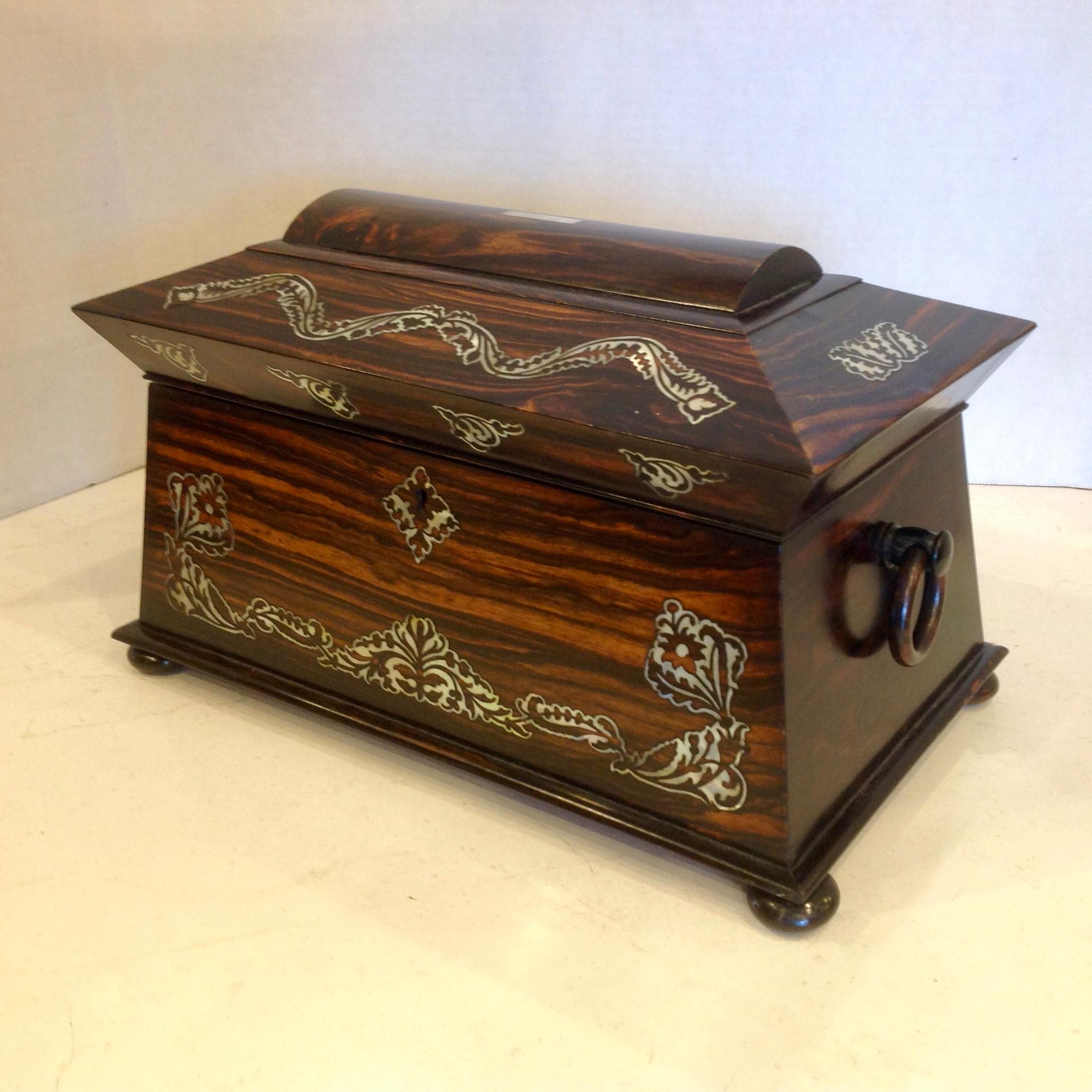 The quintessential rosewood caddy fashioned with a dome top and inlaid with mother of pearl.
Wood 