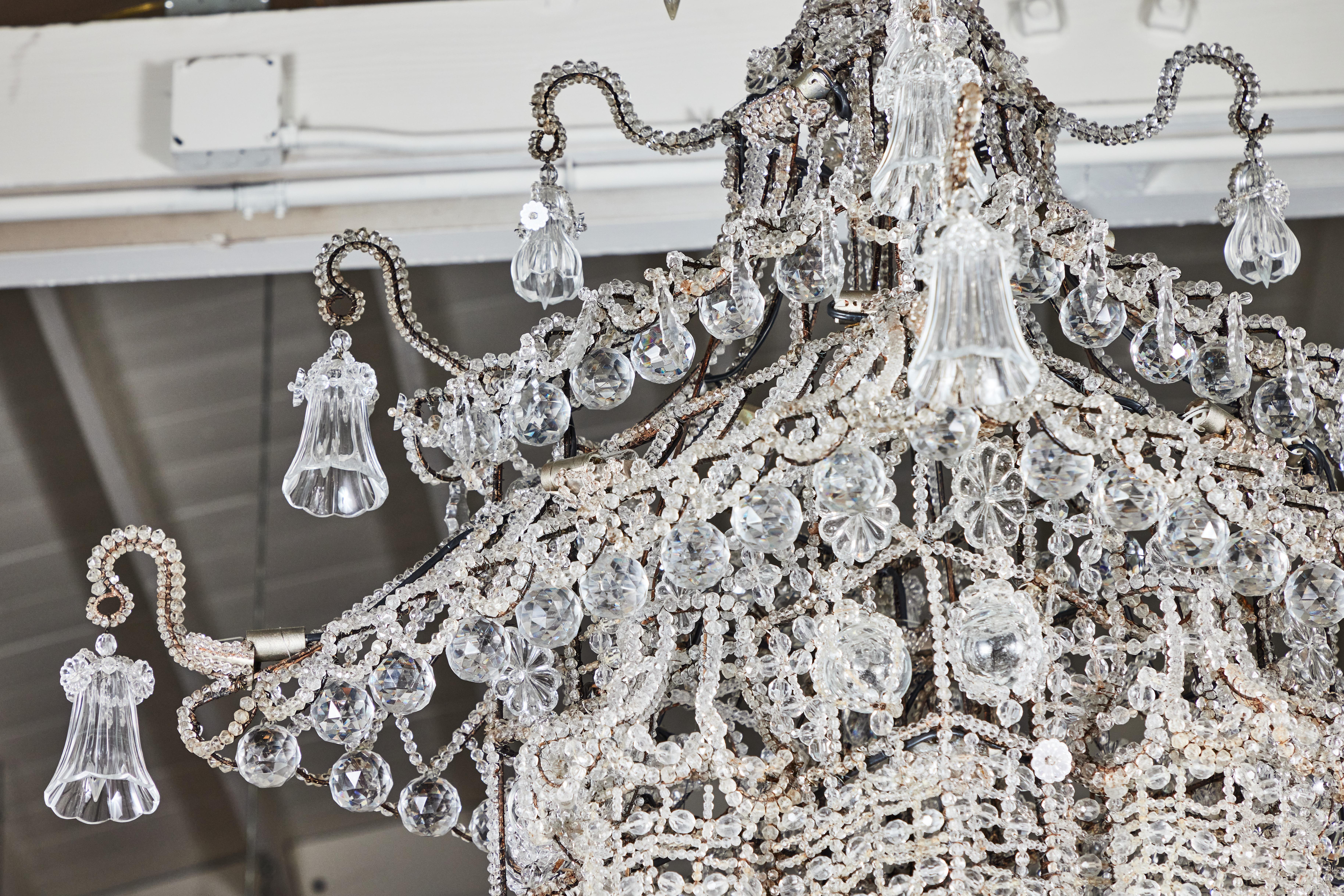 Remarkable, grand, crystal and hand-beaded, Sicilian pagoda chandelier featuring protruding turrets and a tiered upper level embellished with cascading, floral form drops. From the famous, Crespi-Hicks Estate in Dallas, Texas which was redesigned in