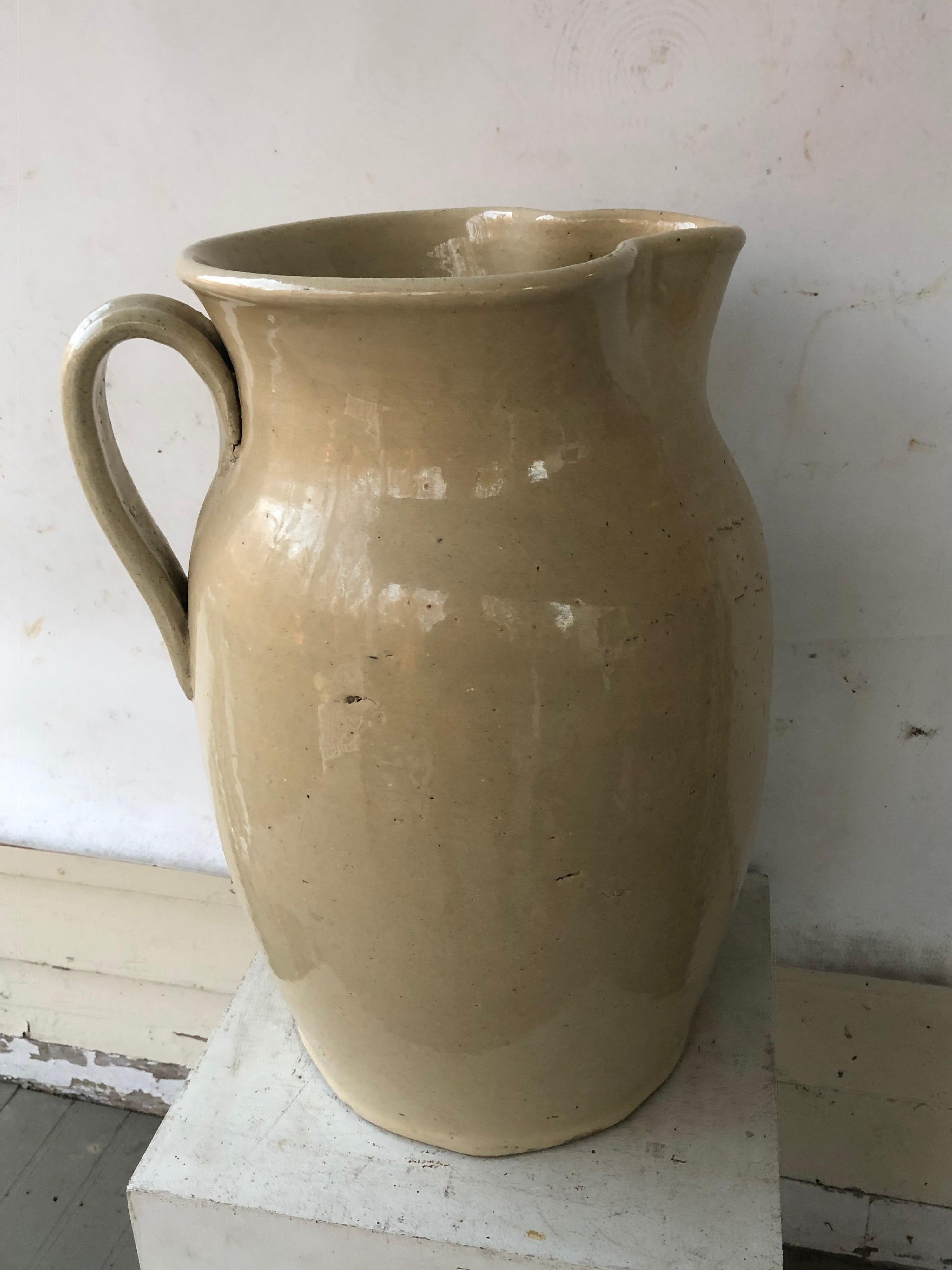 Amazingly large cream glazed English pottery pitcher. Great for flowers arrangements or as an umbrella stand.