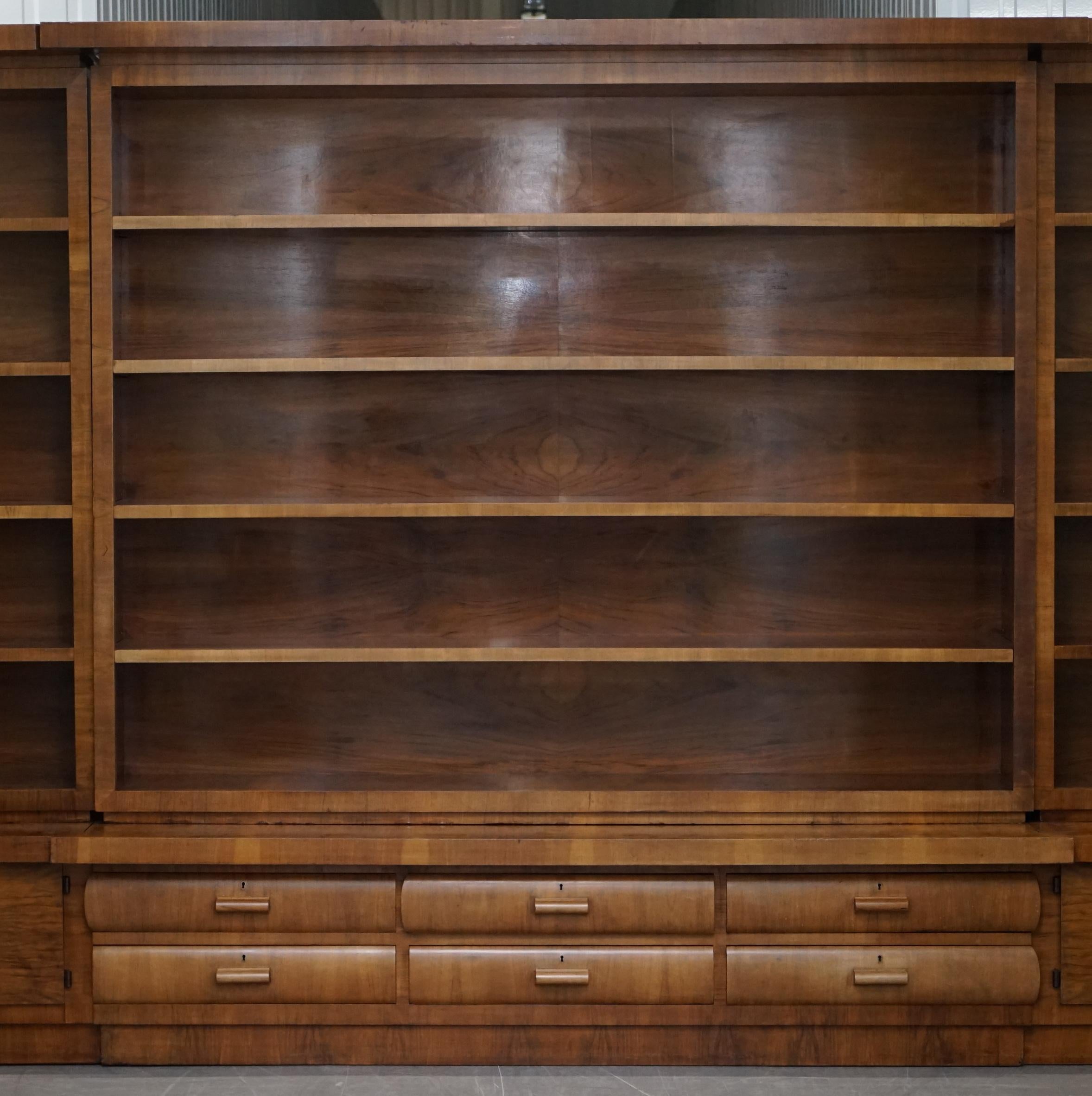 We are delighted to offer for sale this absolutely enormous 5-meter wide solid walnut breakfront bookcase with twin cupboards and bank of drawers

Where to begin, this is a monumental piece of furniture, it comes in three main sections, the two