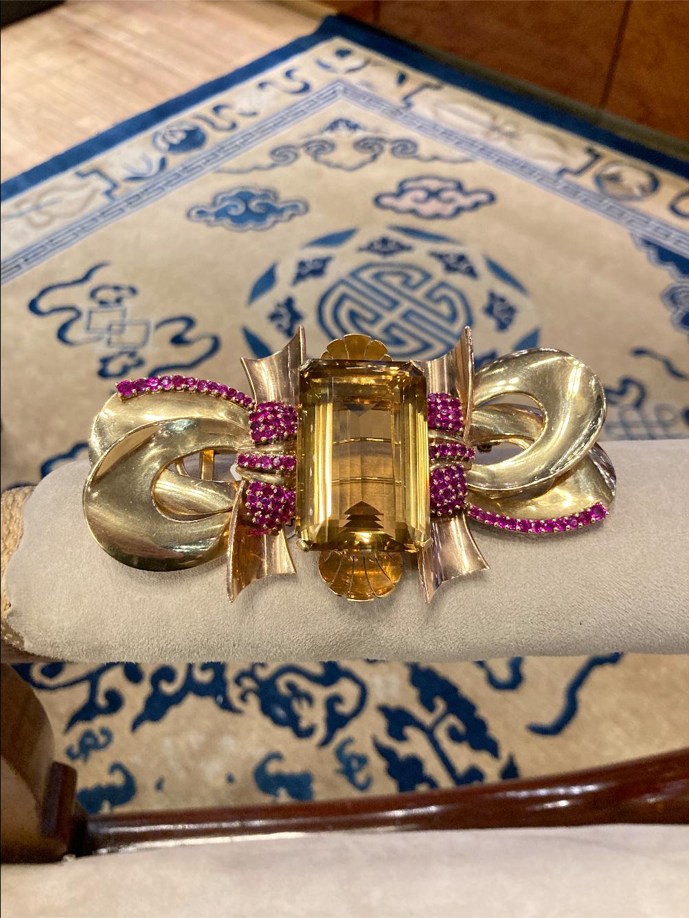 An enormous retro brooch in 14 karat yellow gold with citrine and rubies. Made in the USA, circa 1940.