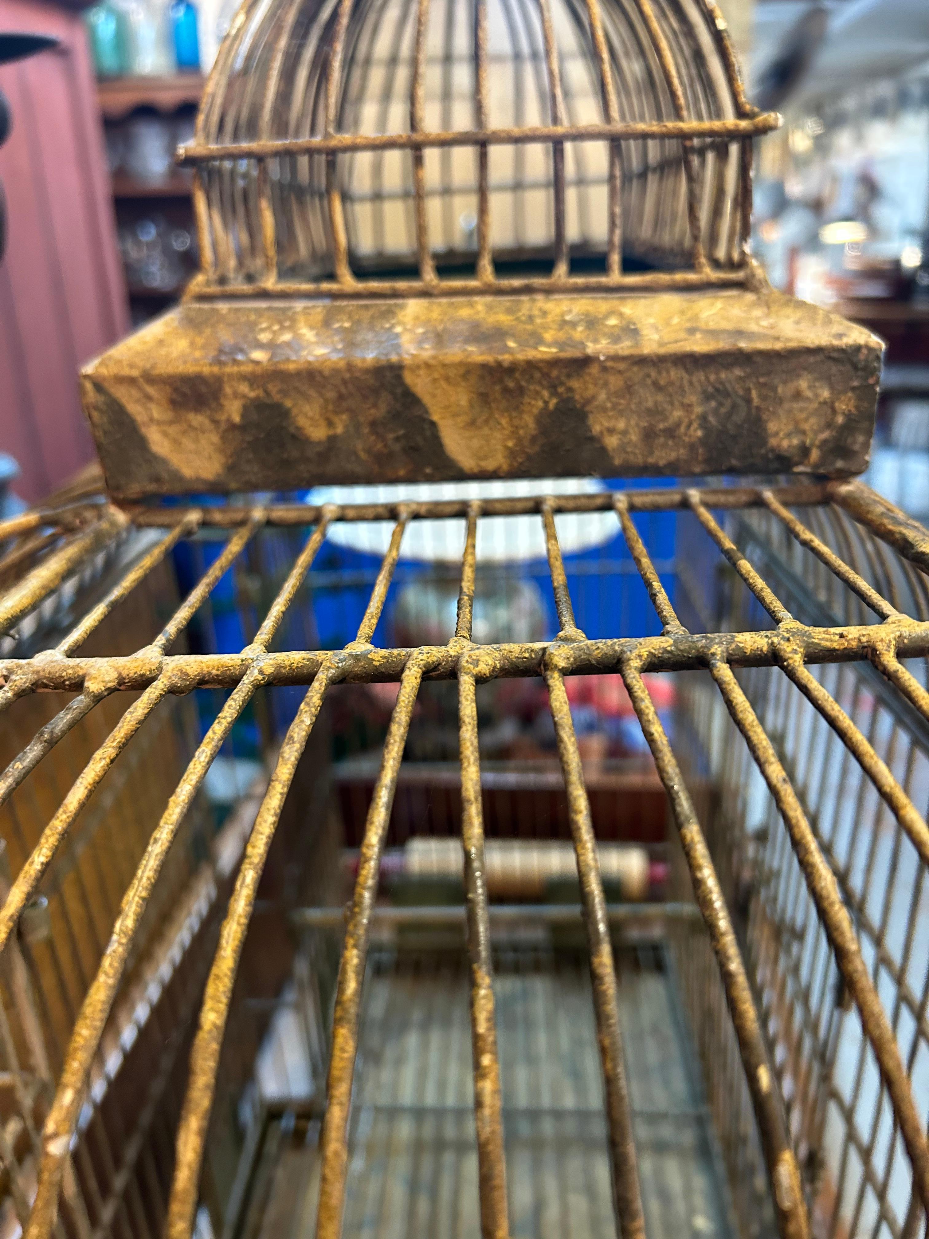 Magical extremely large vintage metal bird cage having a bump out at the back. Distressed condition, but functional.
13.25 deep with 2” bump out at back