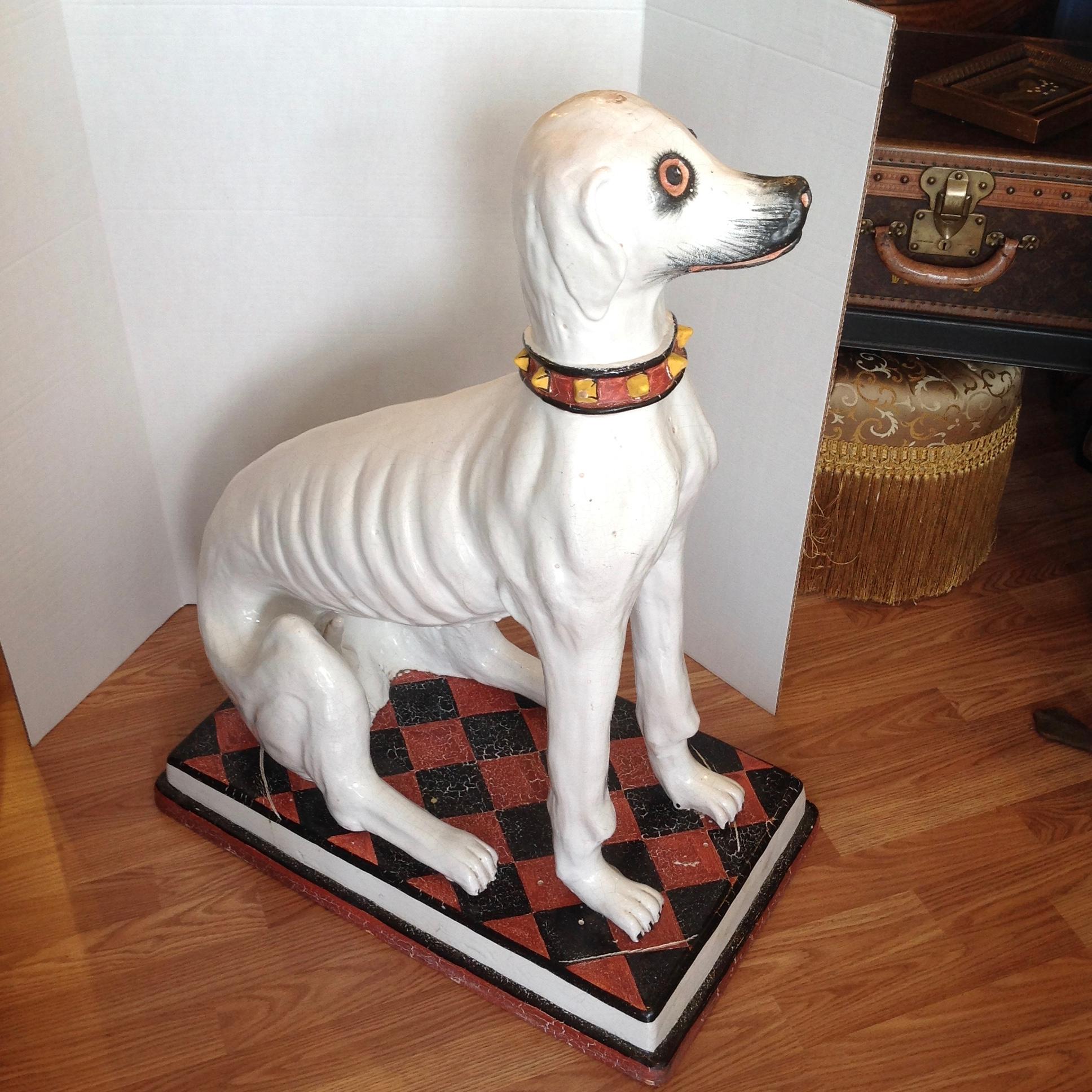 A substantial terra cotta rendering with a glazed finish.
The dog is sitting on a 