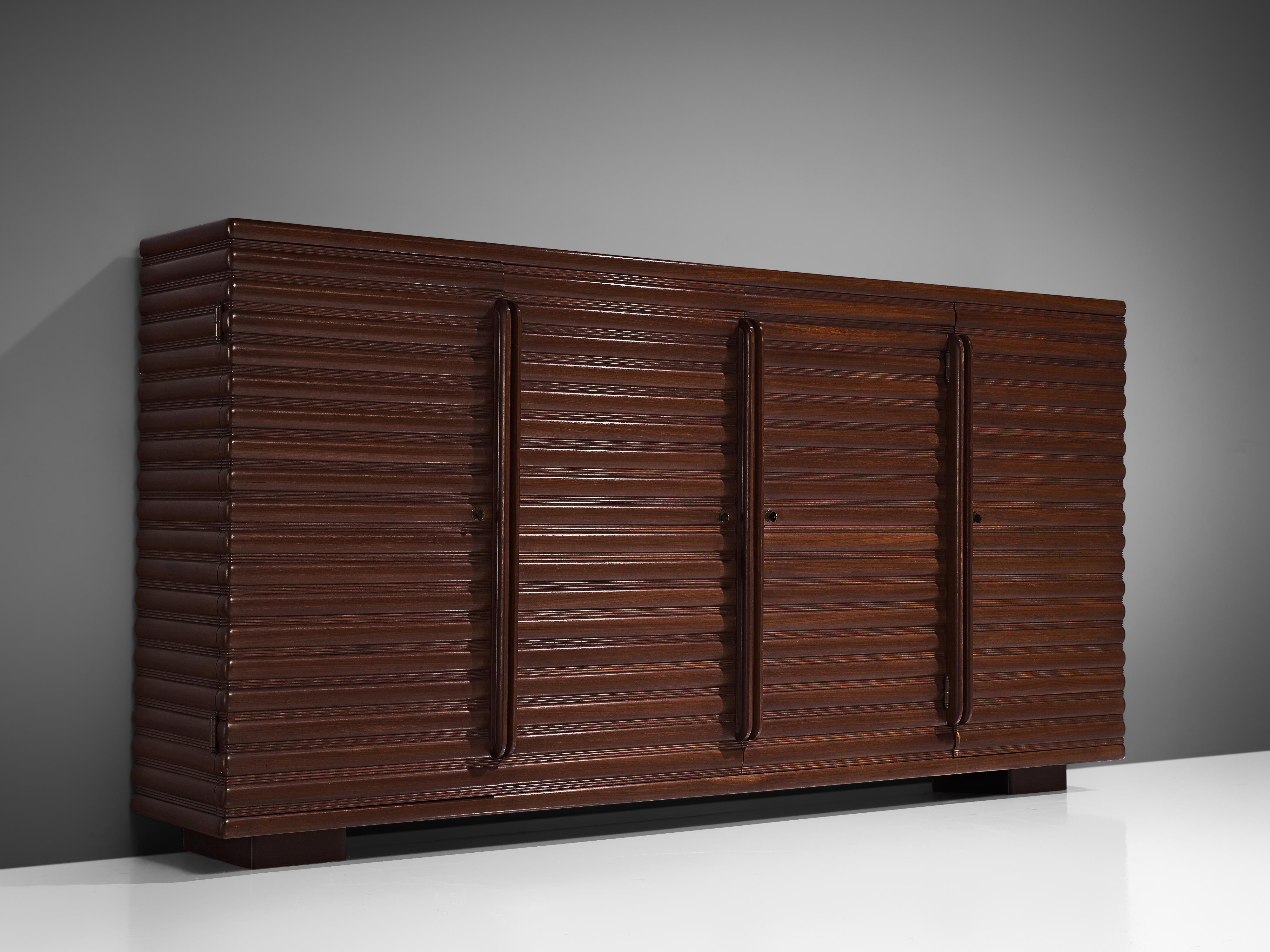 Enrico and Paolo Borghi, sideboard, oak, Italy, 1950s.

Beautiful and elegant Italian sideboard with carved surface. It shows a pattern stained wooden structure, build up from repeating horizontal lines. The side board is high and rests on two