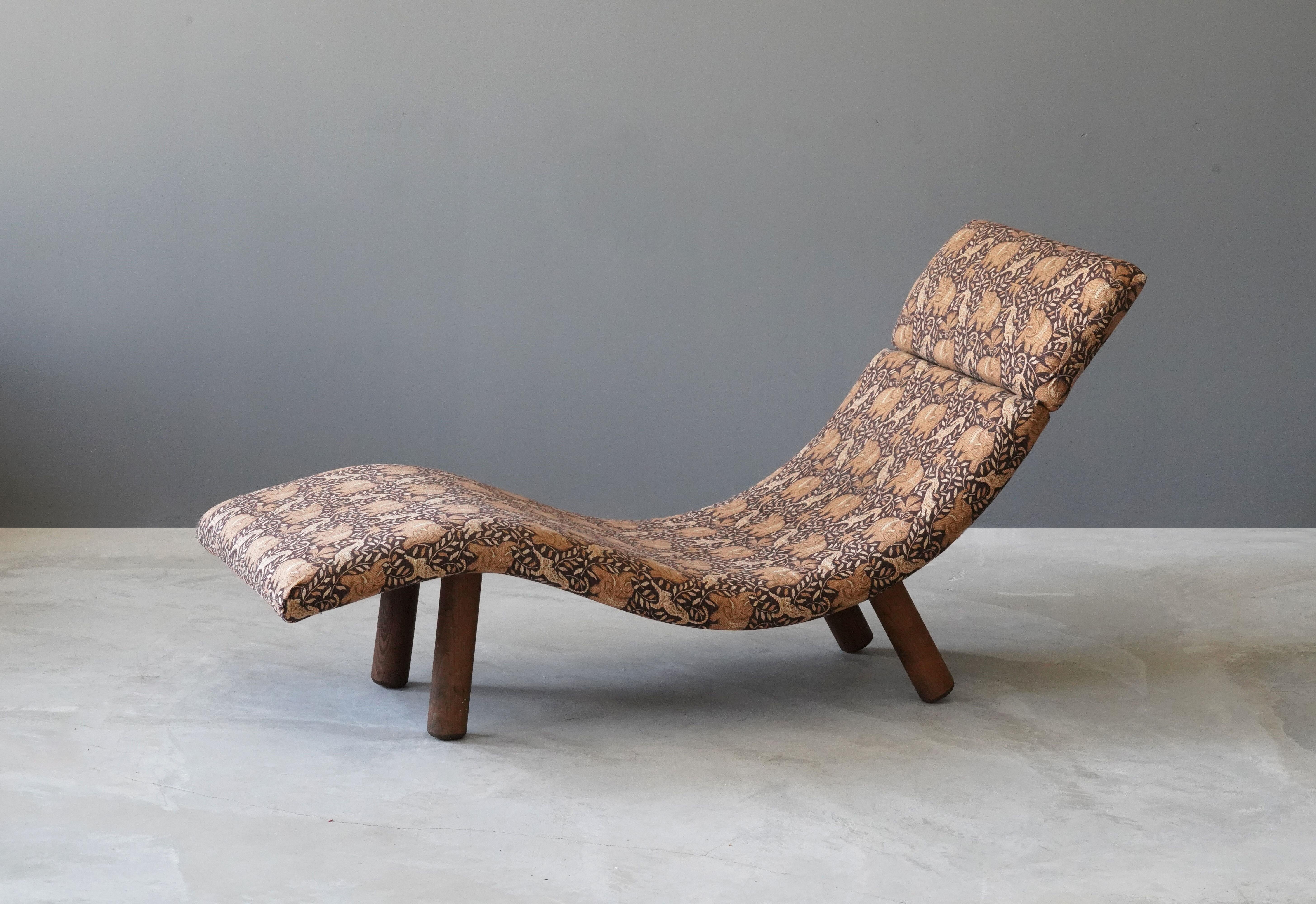 A chaise longue / daybed. Design and production attributed to Enrico Bartolini, USA, 1970s.

Features soft overstuffed forms paired with sculptural solid oak legs.

Other designers of the period include Philip Arctander, Arnold Madsen, Vladimir