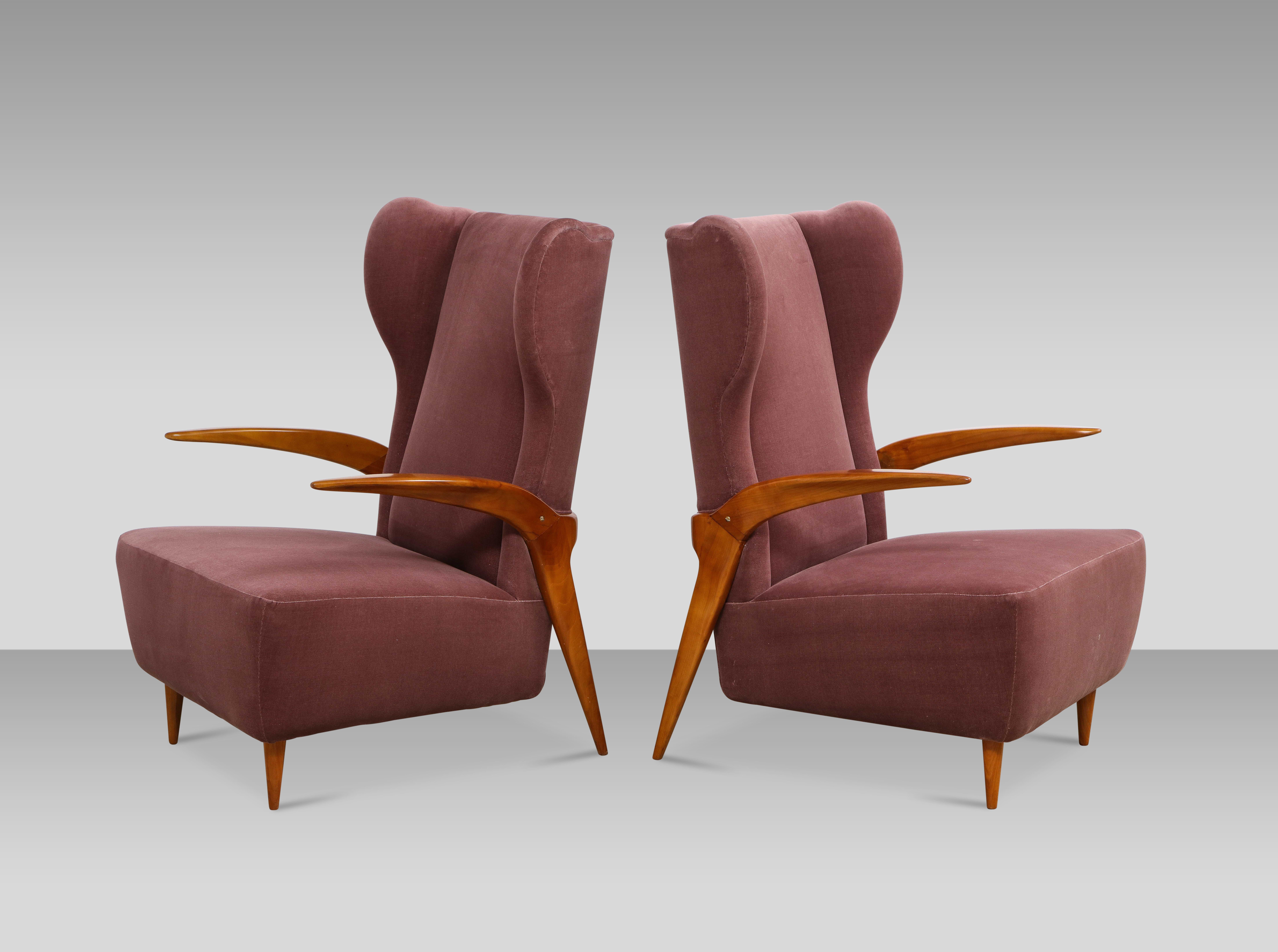 Pair of sculptural lounge chairs attributed to Enrico Ciuti. Elegant open armchairs of cherrywood, and upholstered seat with winged-backrest. Great details to overall form.