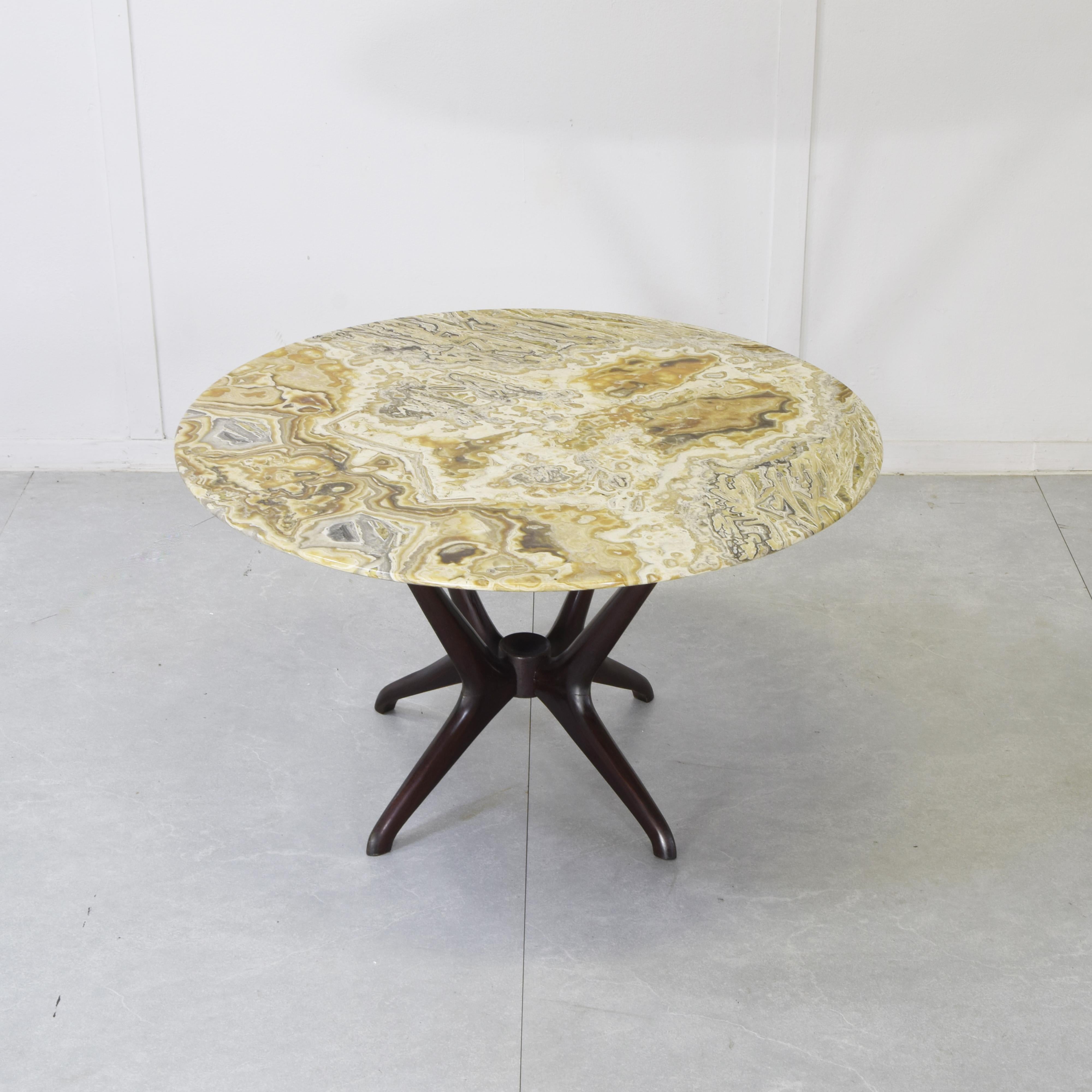 Coffee table by Enrico Ciuti, produced by Cassina in the 1950s. The supporting structure is in dark Italian walnut and the base is in Pakistani onyx.
Enrico Ciuti (born in Milan in 1910, died in Lugano, Switzerland, in 1991) was a multifaceted