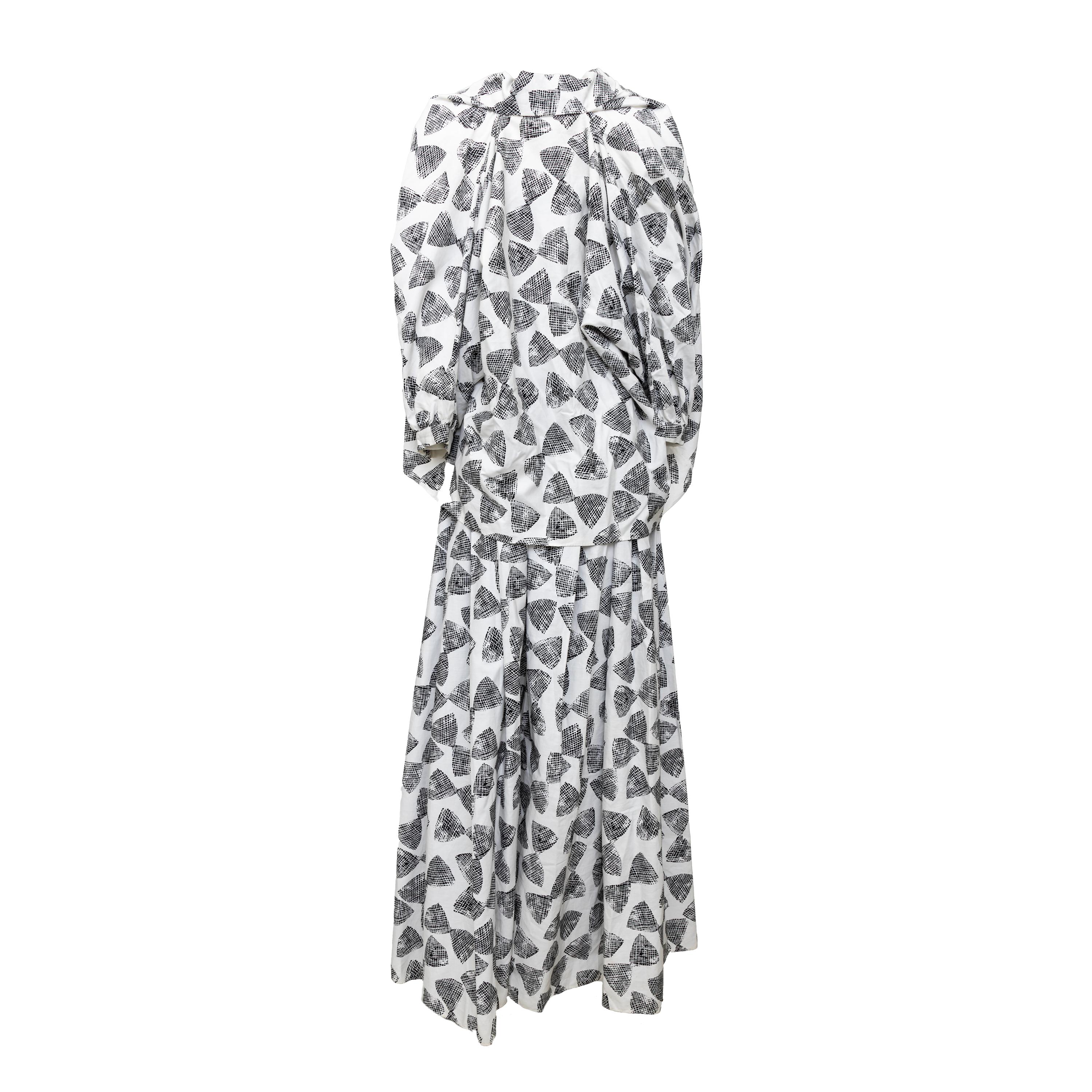 Step into retro chic with the Enrico Coveri Jumpsuit and Jacket Set from the 80s. The strapless jumpsuit boasts boning and silk panels for a flattering fit, while the flowy bottom and matching jacket with a relaxed, kimono-style fit complete the