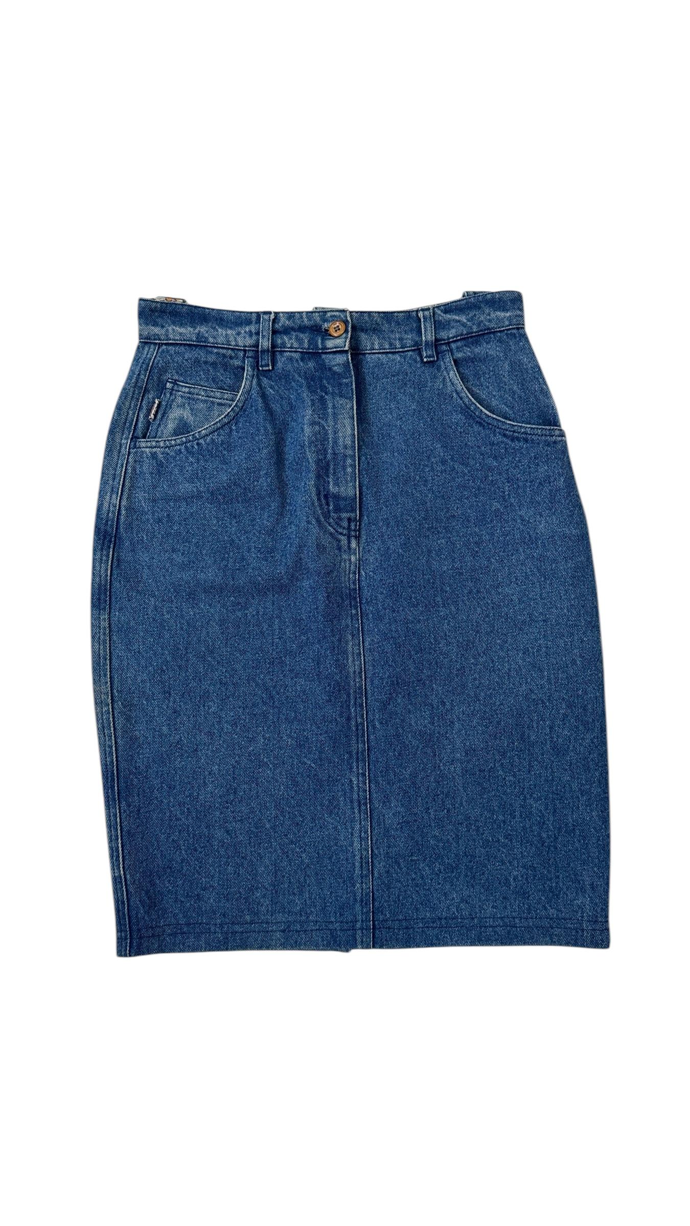 A rare and collectible piece from Italian designer Enrico Coveri, this structured high-waisted denim skirt perfectly captures the playful and irreverent spirit of late 1980s Italian fashion.

Crafted in classic medium-wash cotton denim, the skirt