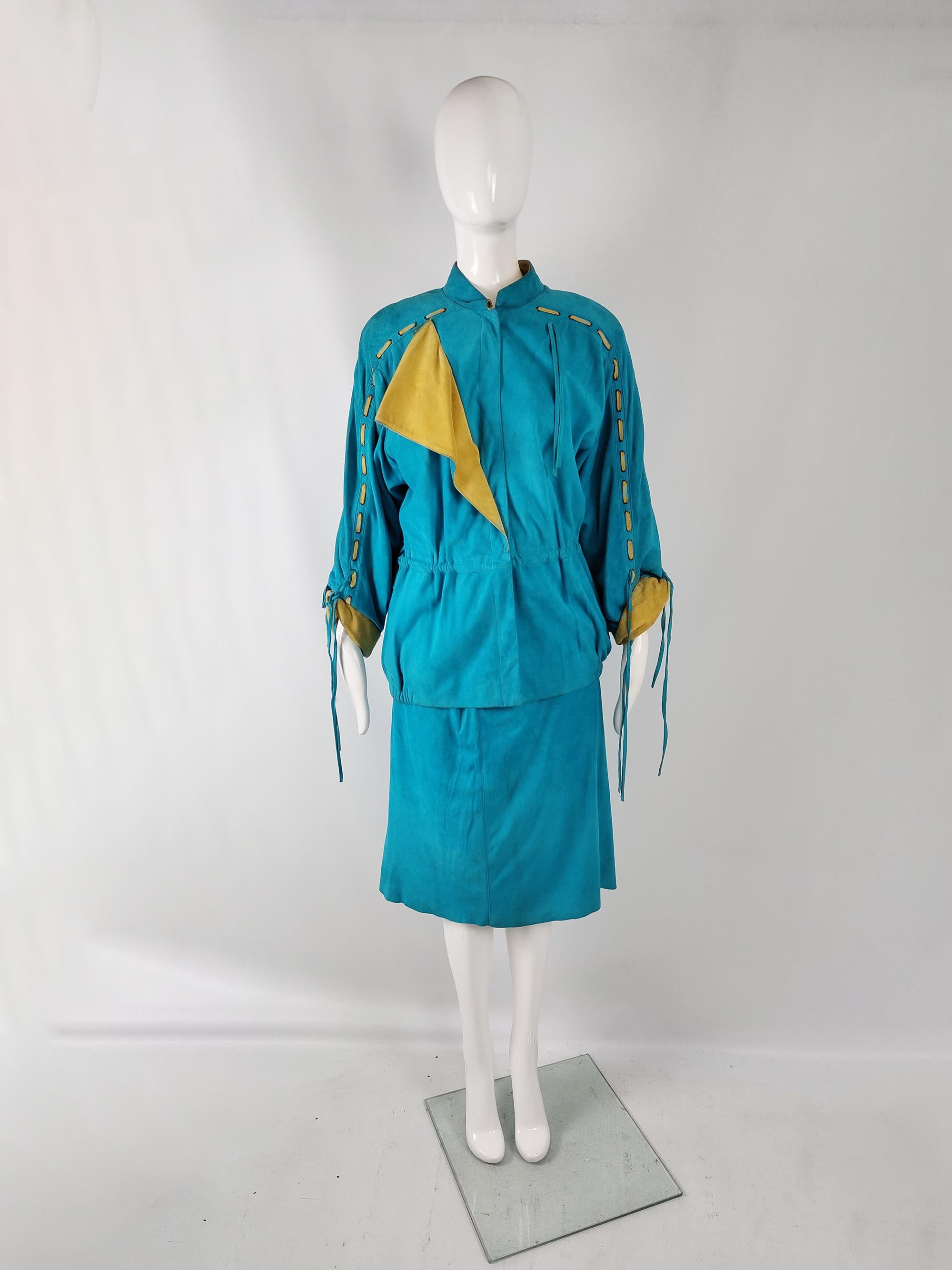 An incredible and rare vintage womens two piece skirt suit from the 80s by luxury Italian fashion designer, Enrico Coveri. Made in Italy, from a vibrant turquoise / teal colour real suede fabric. It consists of a jacket with a very loose, oversized
