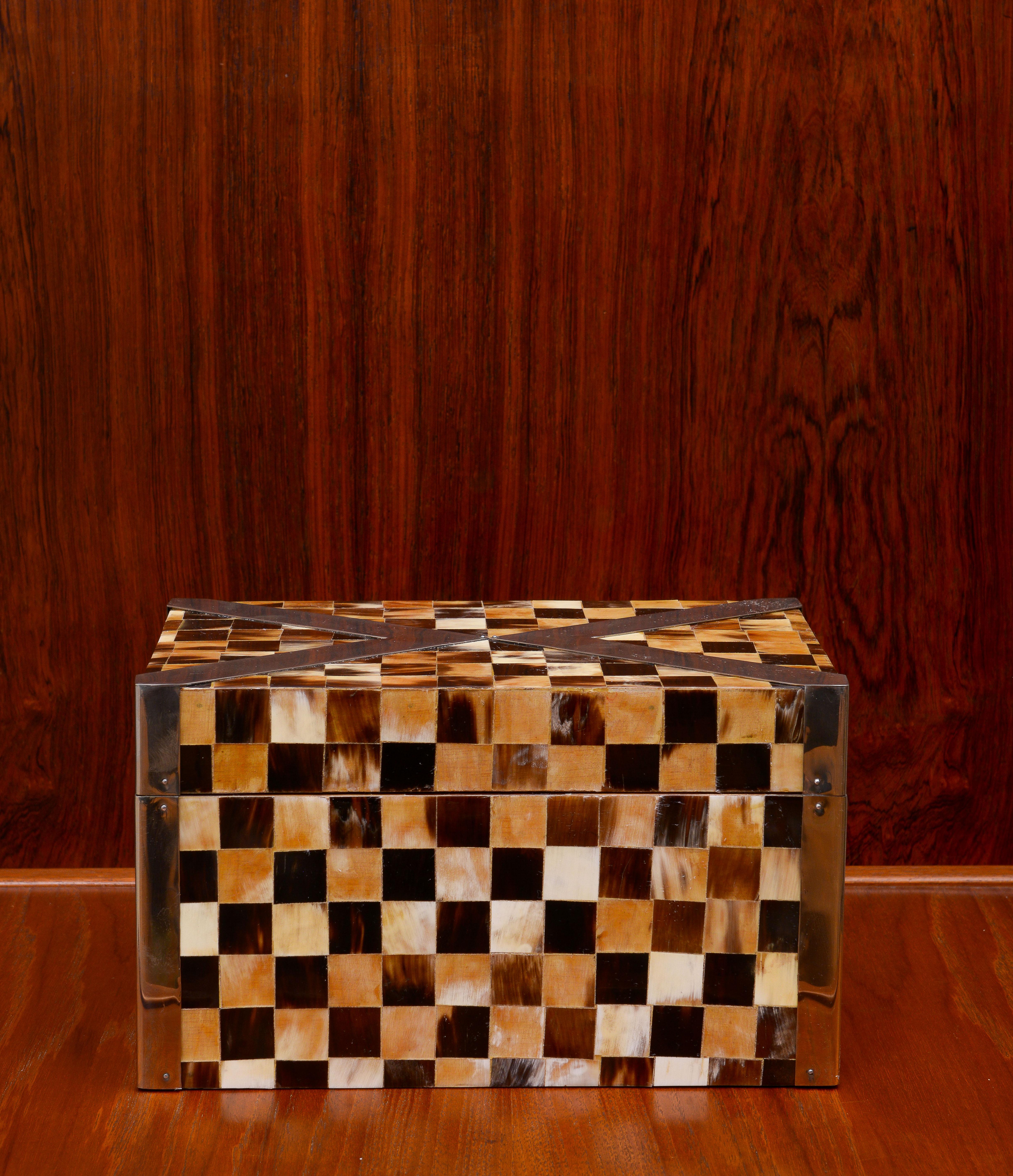 One absolutely gorgeous decorative box by Enrique Garcel 1980s. In two tone tessellated horn and brass bands surrounding it. The brass hinges make this box extremely sturdy with good weight. The box is signed made in Colombia which is where Garcel