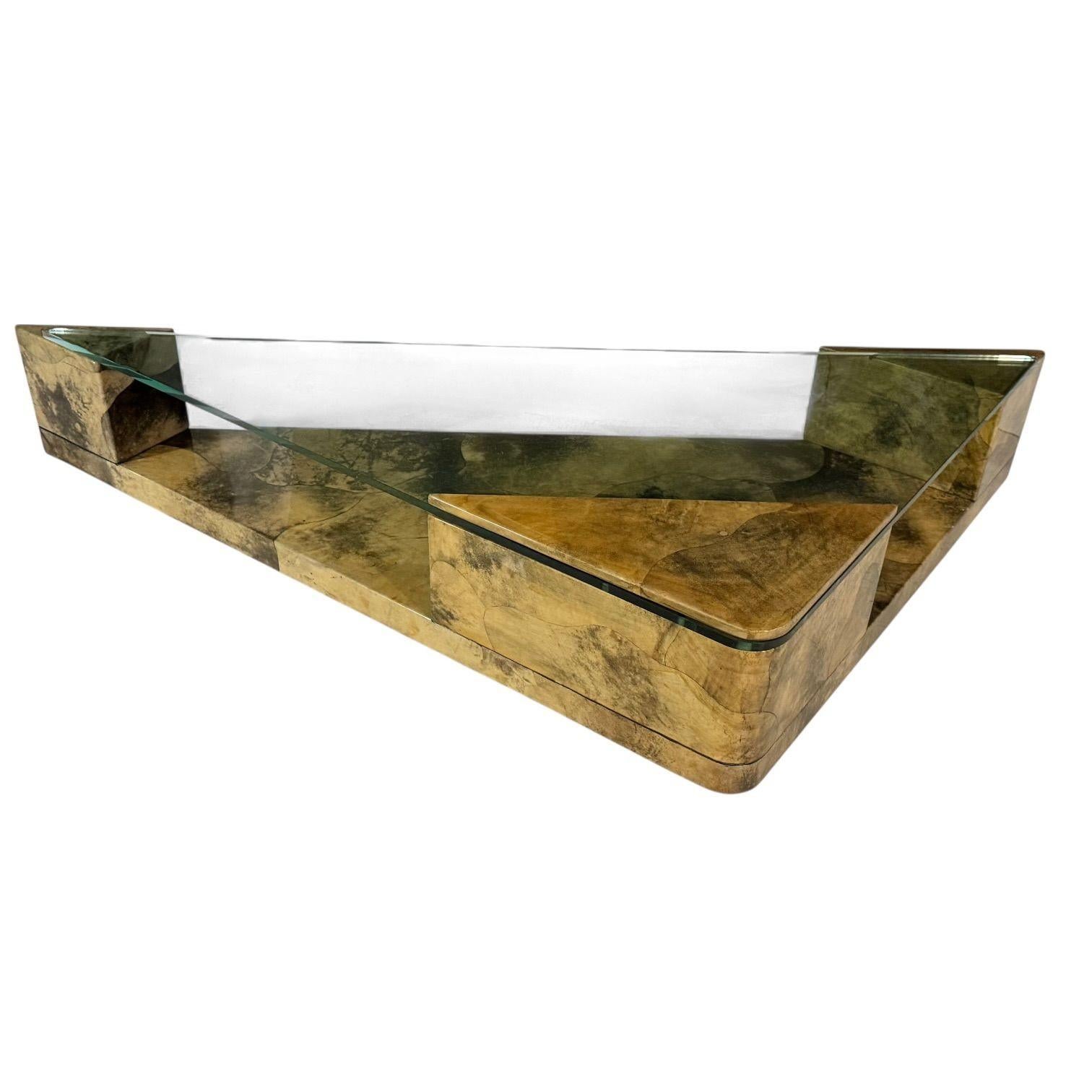 Enrique Garcel Lacquered Goatskin Triangular Coffee Table, 1991.  Matching Side/End tables are in separate listing.
Measures 17.75” tall 91.5” long 42” deep
